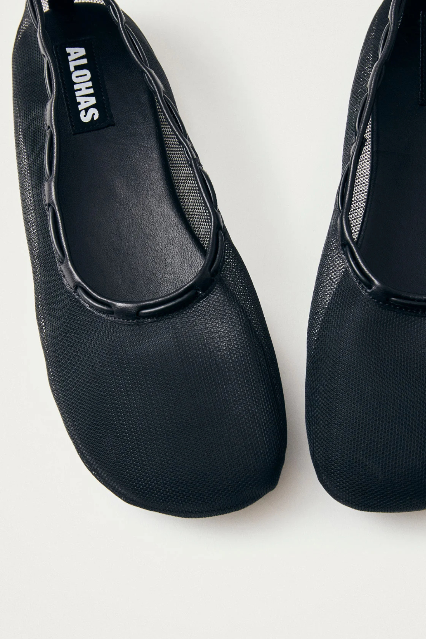 Alohas gill mesh leather ballet flats in black. Front view