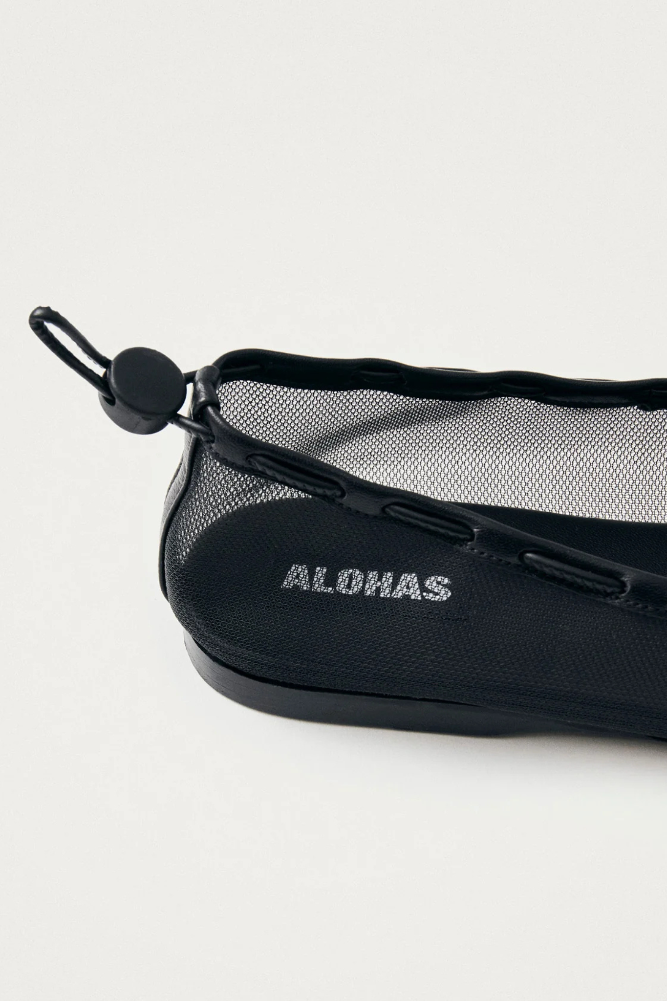 Alohas gill mesh leather ballet flats in black. Close side view