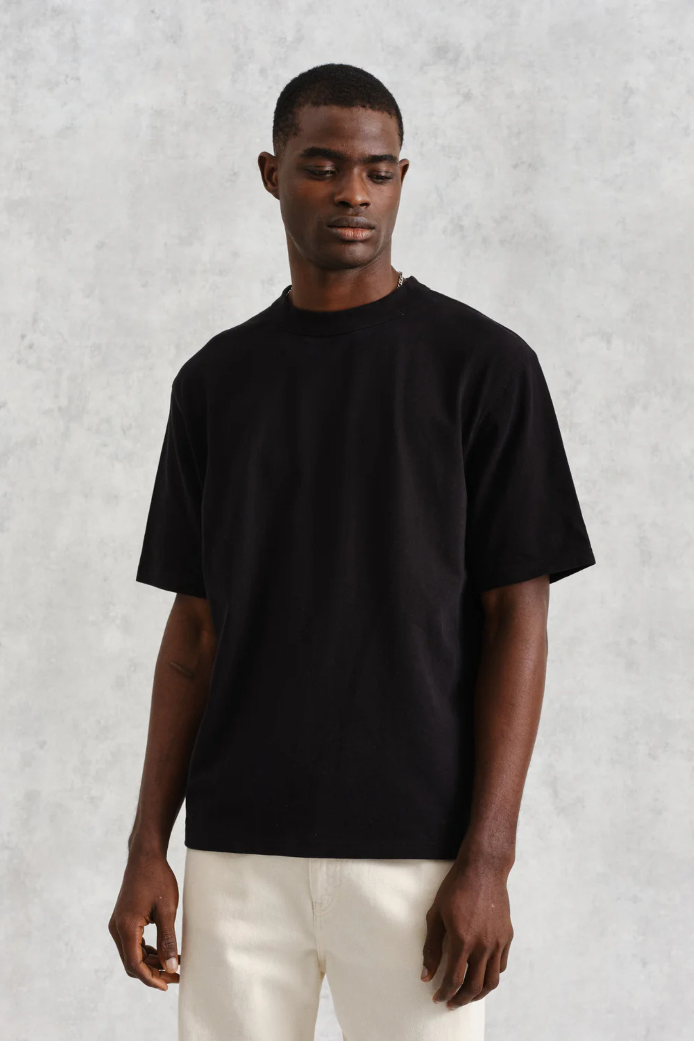 Model wearing the Wax London milton t-shirt in black. Front view
