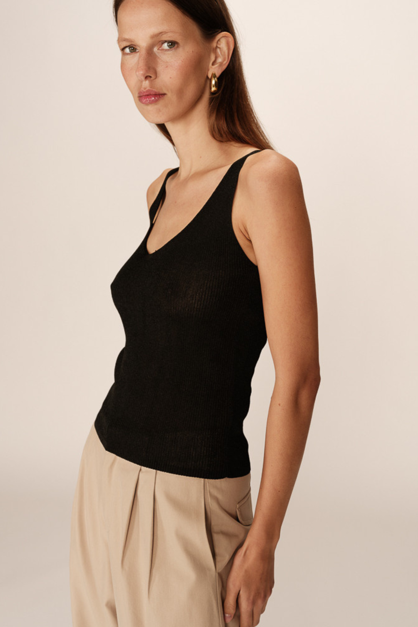 Model wearing the Grace & Mila paillette top in black. Side view