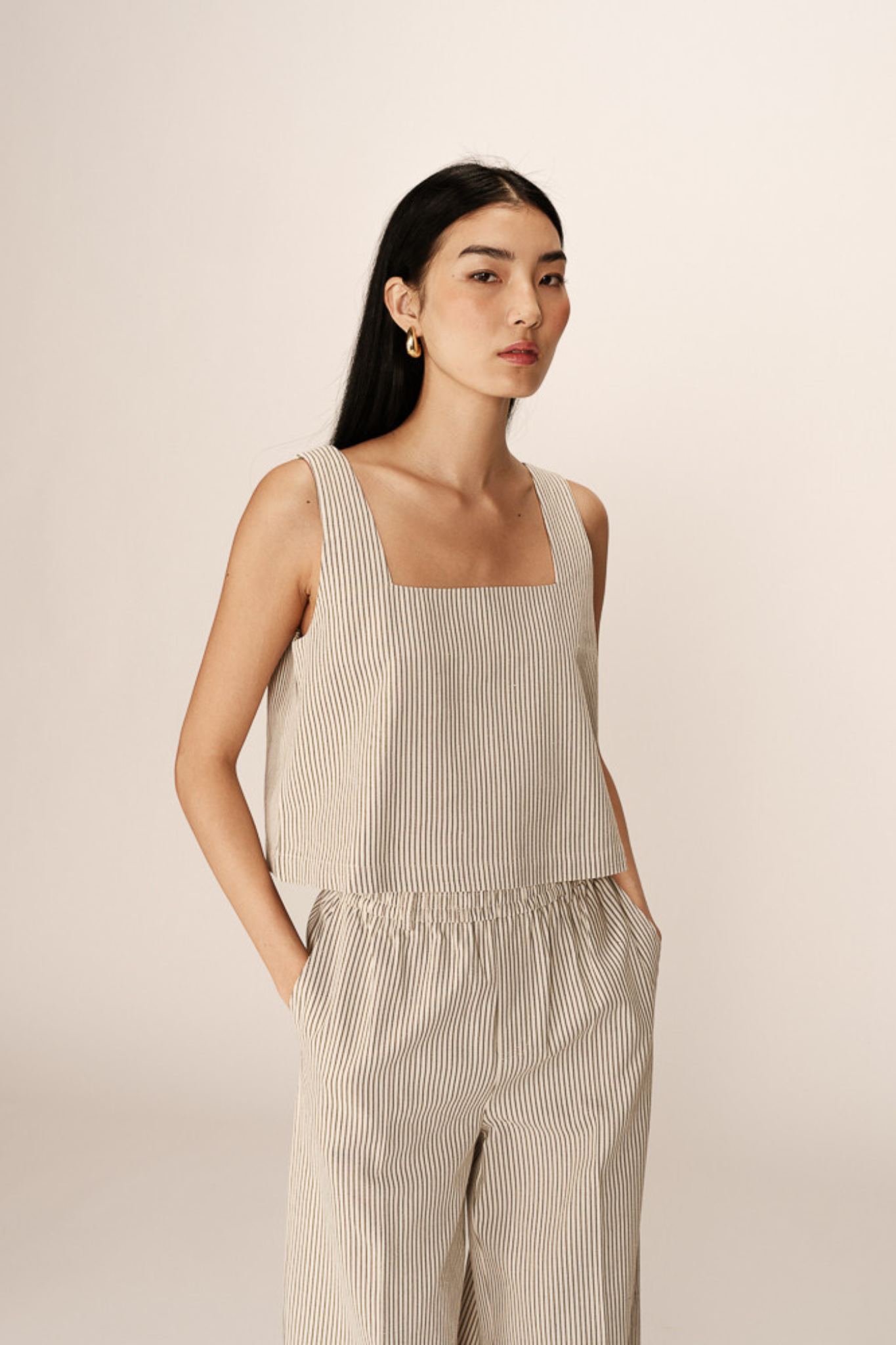 Model wearing the Grace & Mila peanut top in ecru. Front view