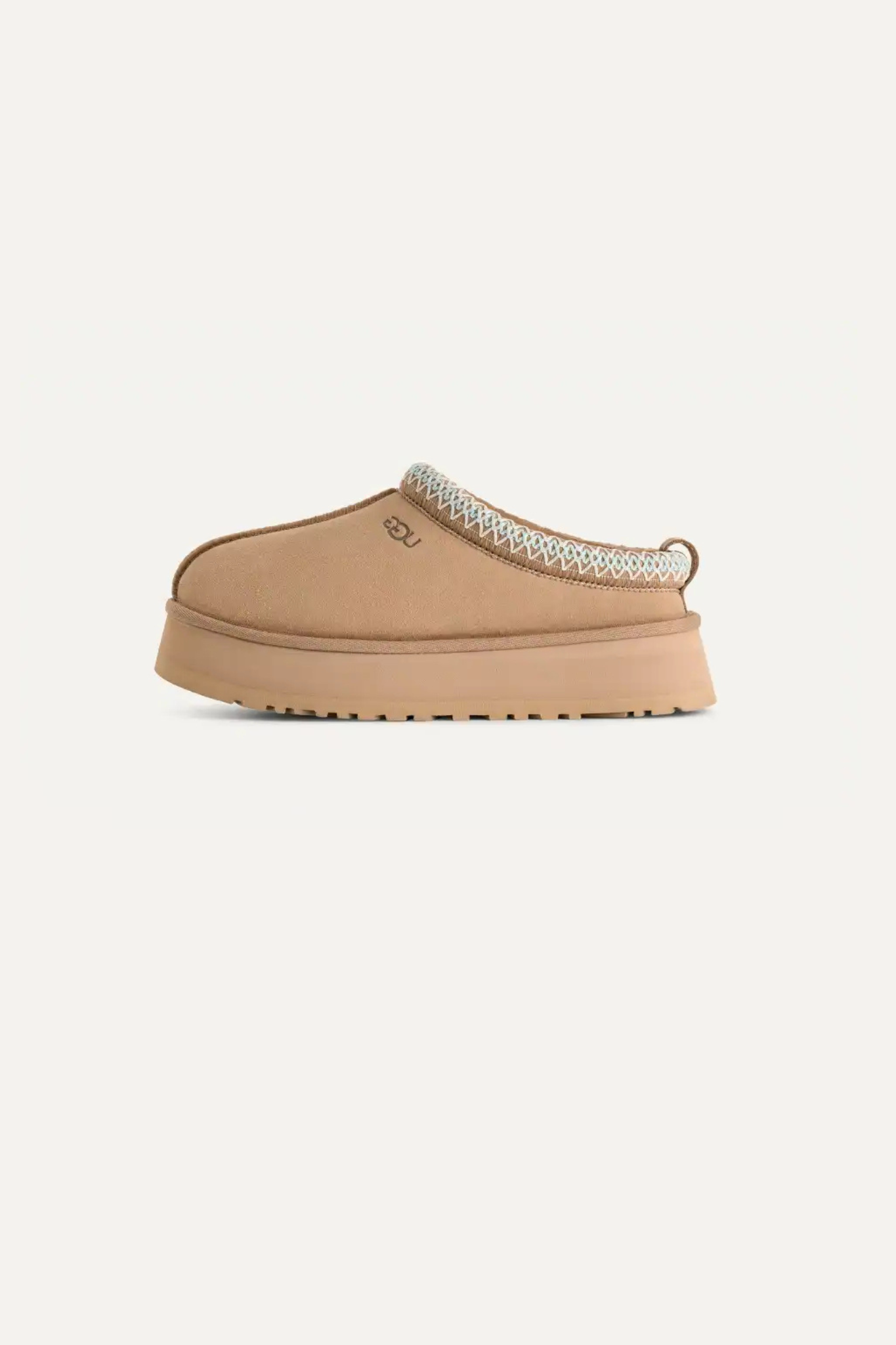 UGG women tazz in sand. Side view