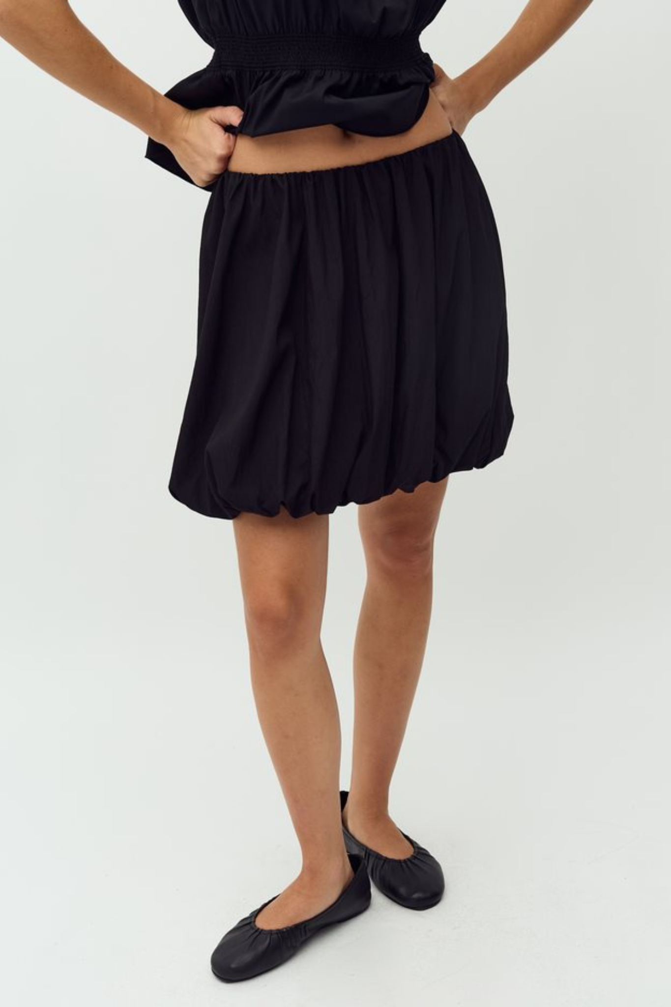 Model wearing the MBYM belaria twilia skirt in black. Front view