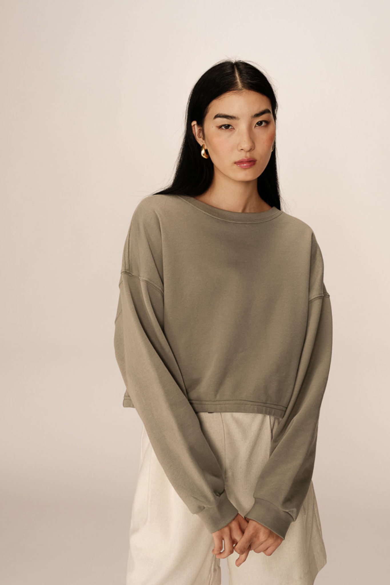 Model wearing the Grace & Mila podium sweatshirt in green. Front view