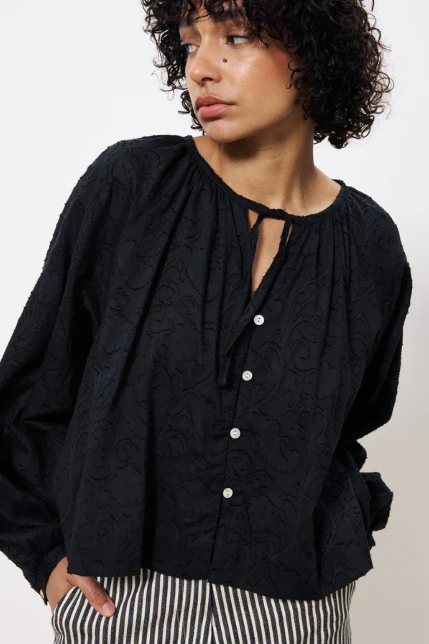 Model wearing the FRNCH cedella shirt in black. Front view
