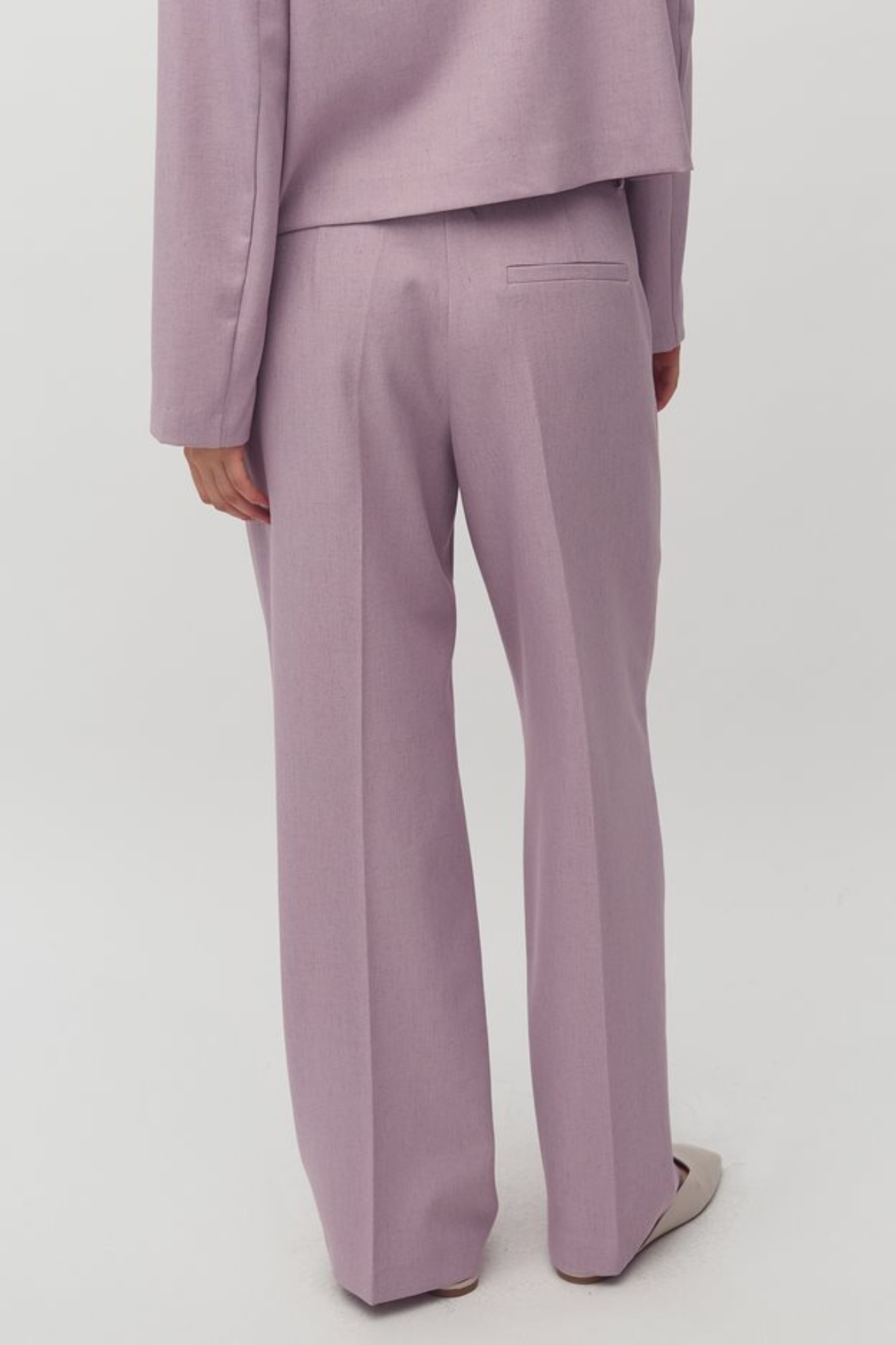 Model wearing the MBYM cristiana morenna pants in orchid bloom. Back view