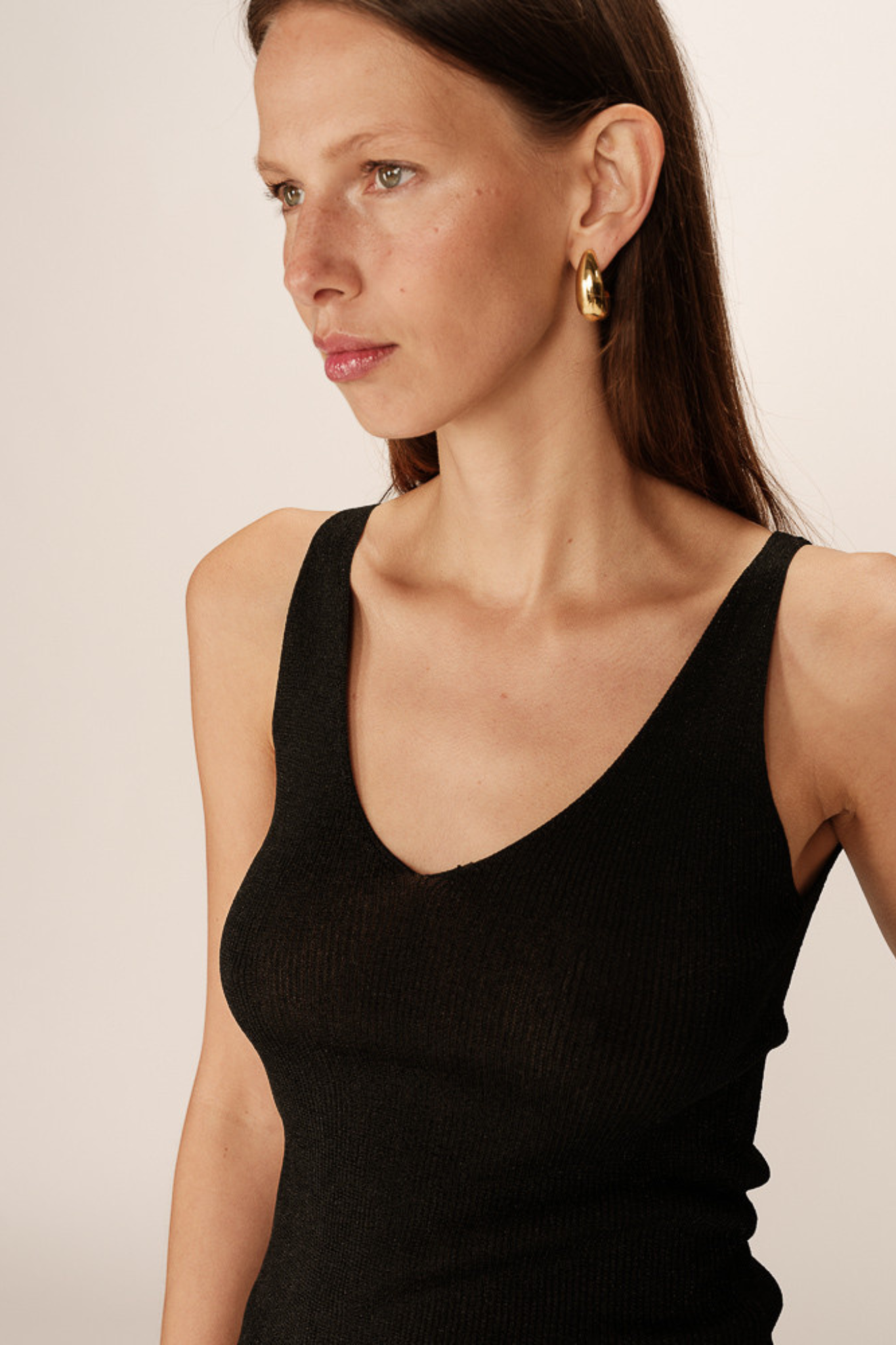 Model wearing the Grace & Mila paillette top in black. Front view