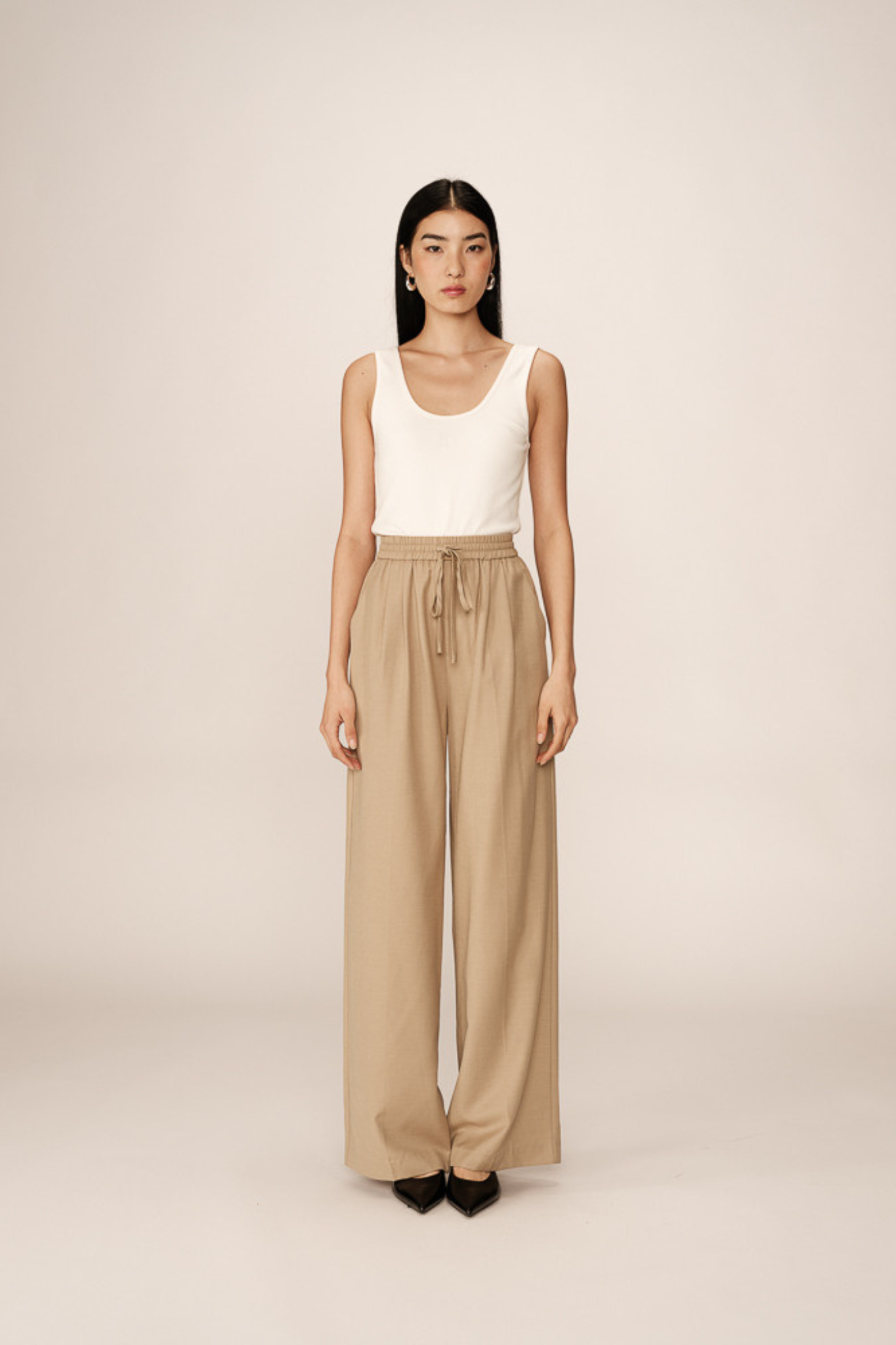 Model wearing the Grace & Mila petro pants in beige. Front view