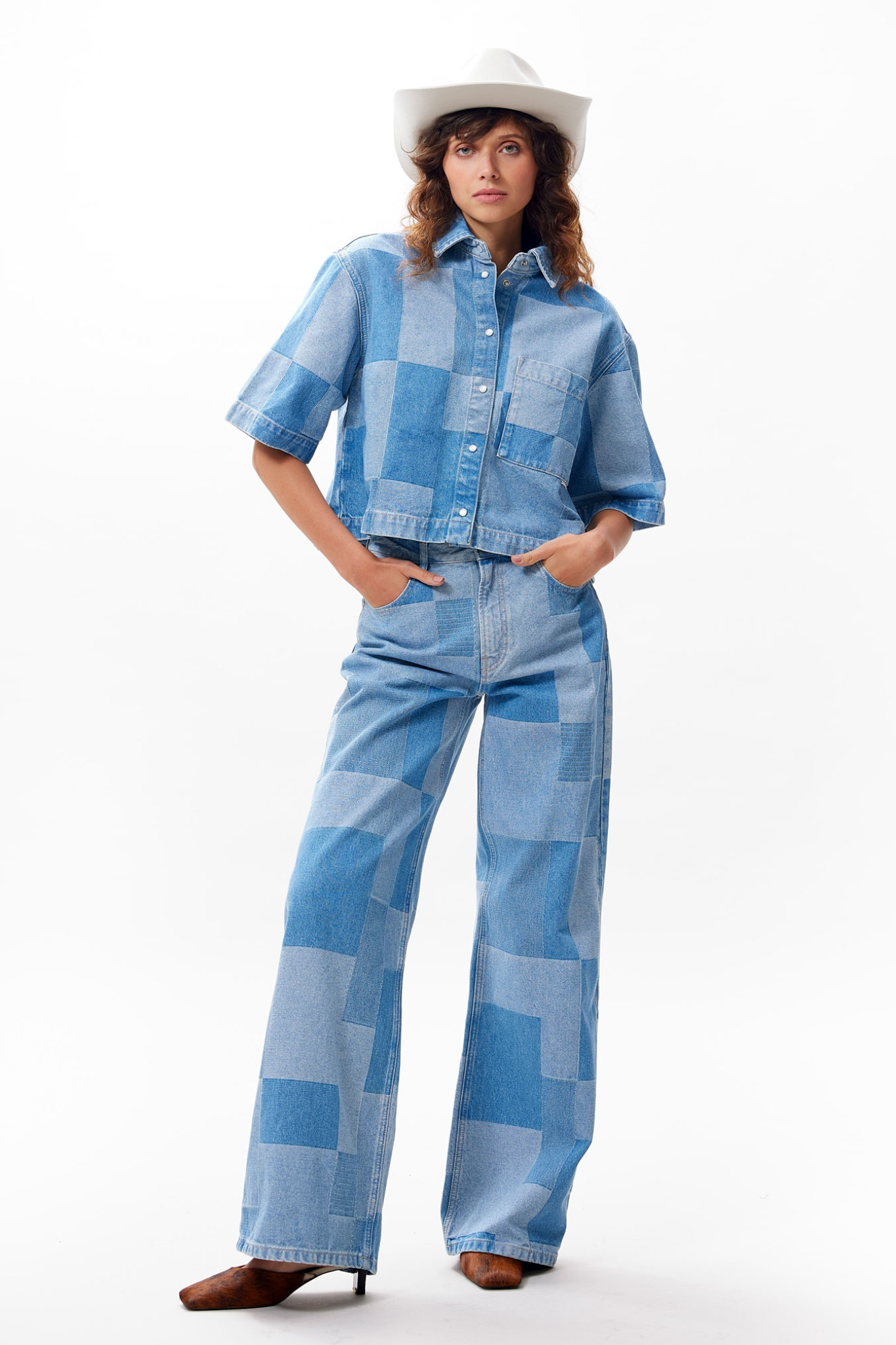 Model wearing the Catwalk Junkie patchwork blouse in blue. Front view
