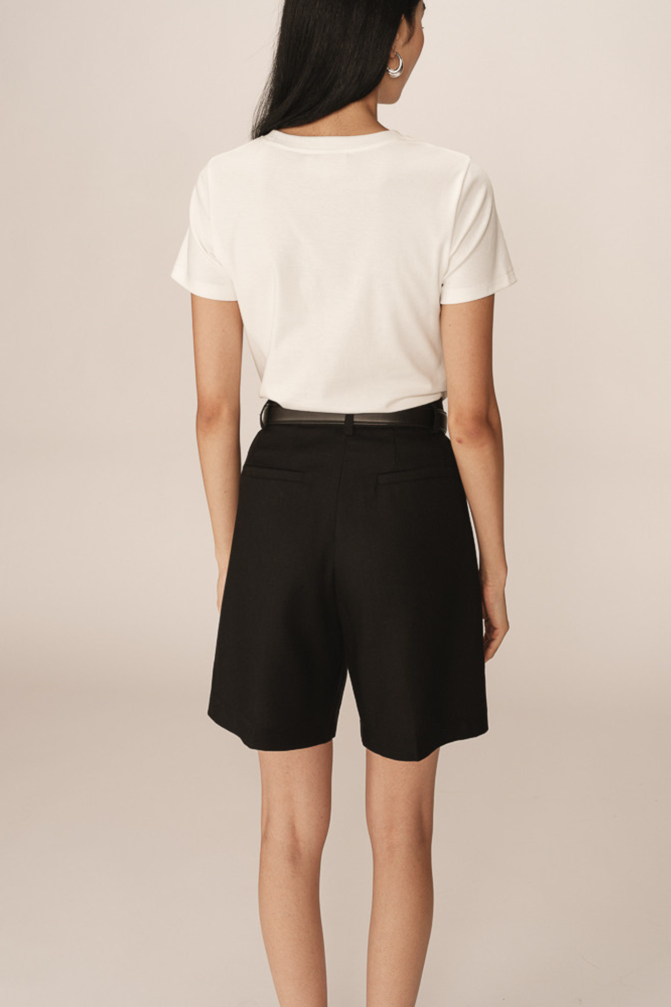 Model wearing the Grace & Mila pastel bermuda short in black. Back view