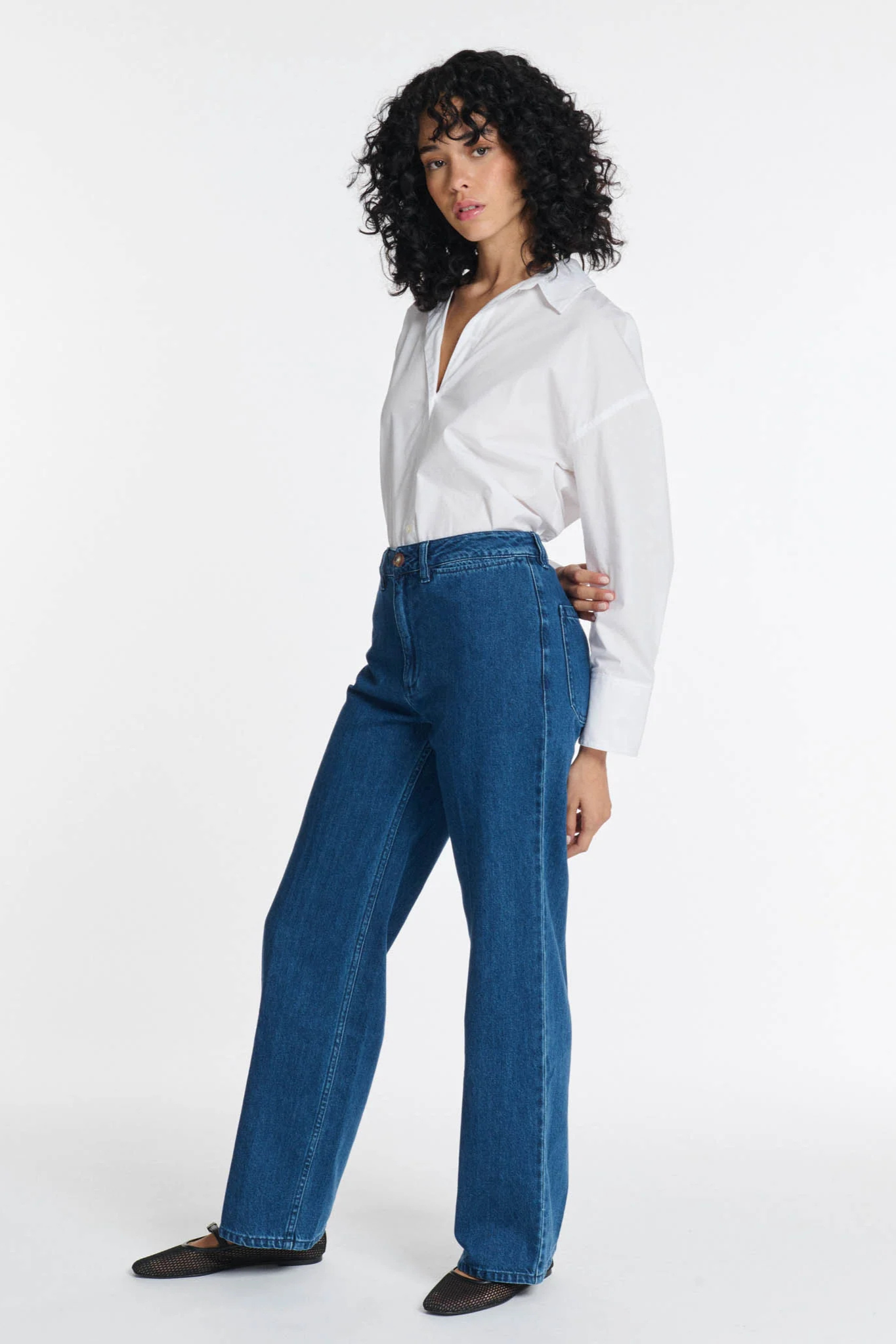 Model wearing the Labdip swann jeans in mid blue. Side view