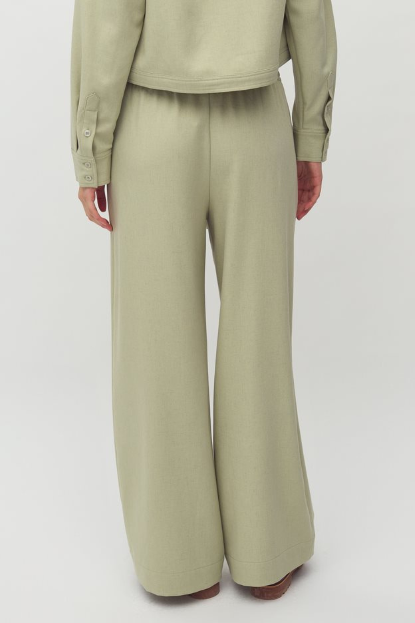 Model wearing the MBYM christoff morenna pants in pistachio/green. Back view
