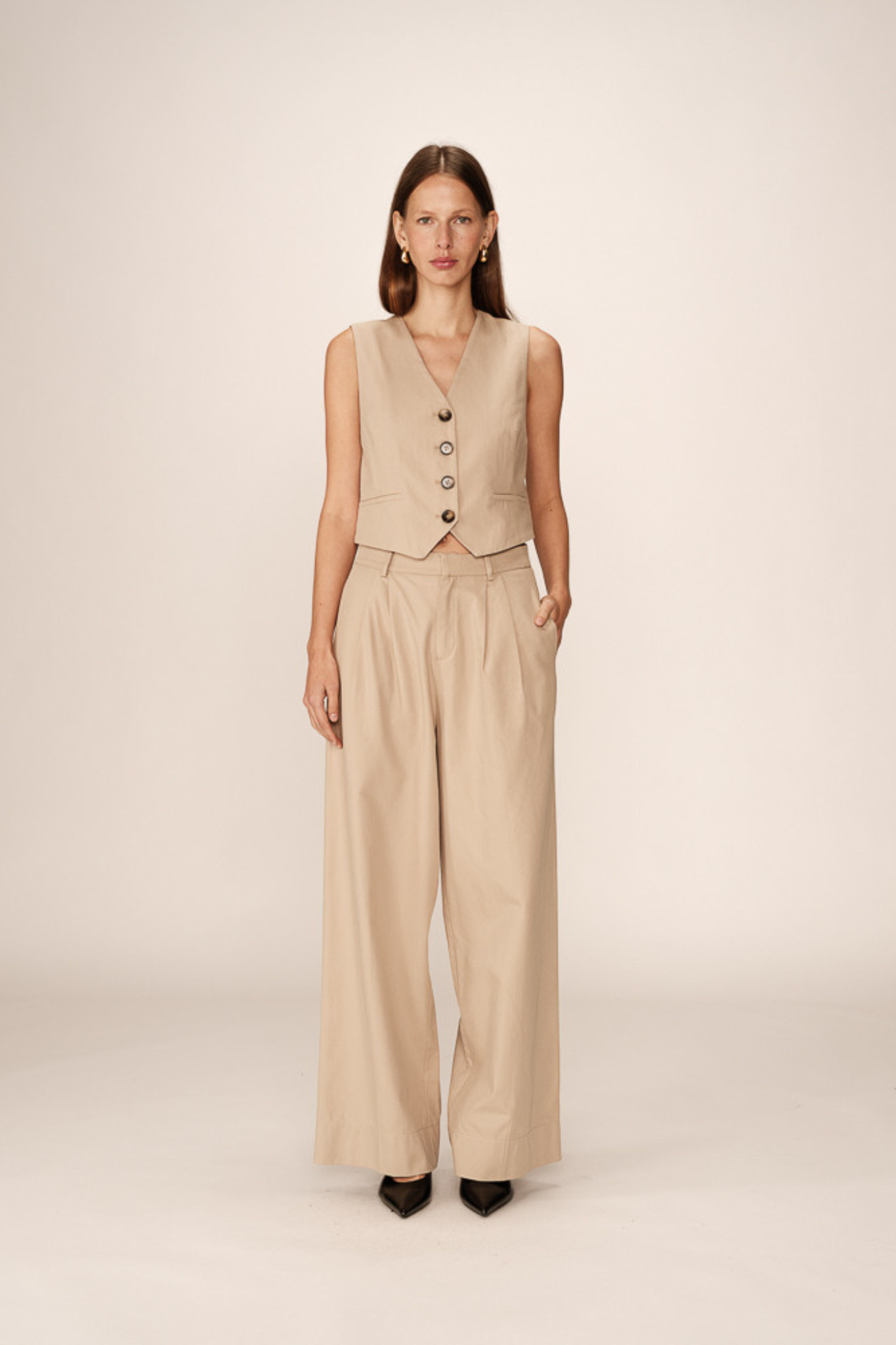 Model wearing the Grace & Mila peter pants in beige. Front view