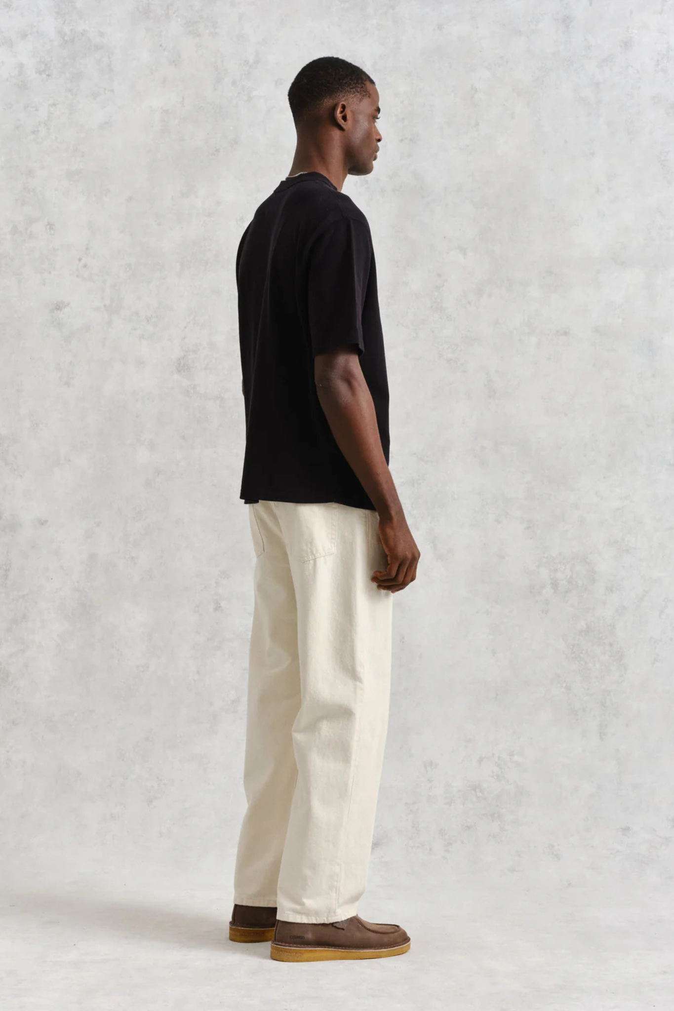 Model wearing the Wax London milton t-shirt in black. Side view