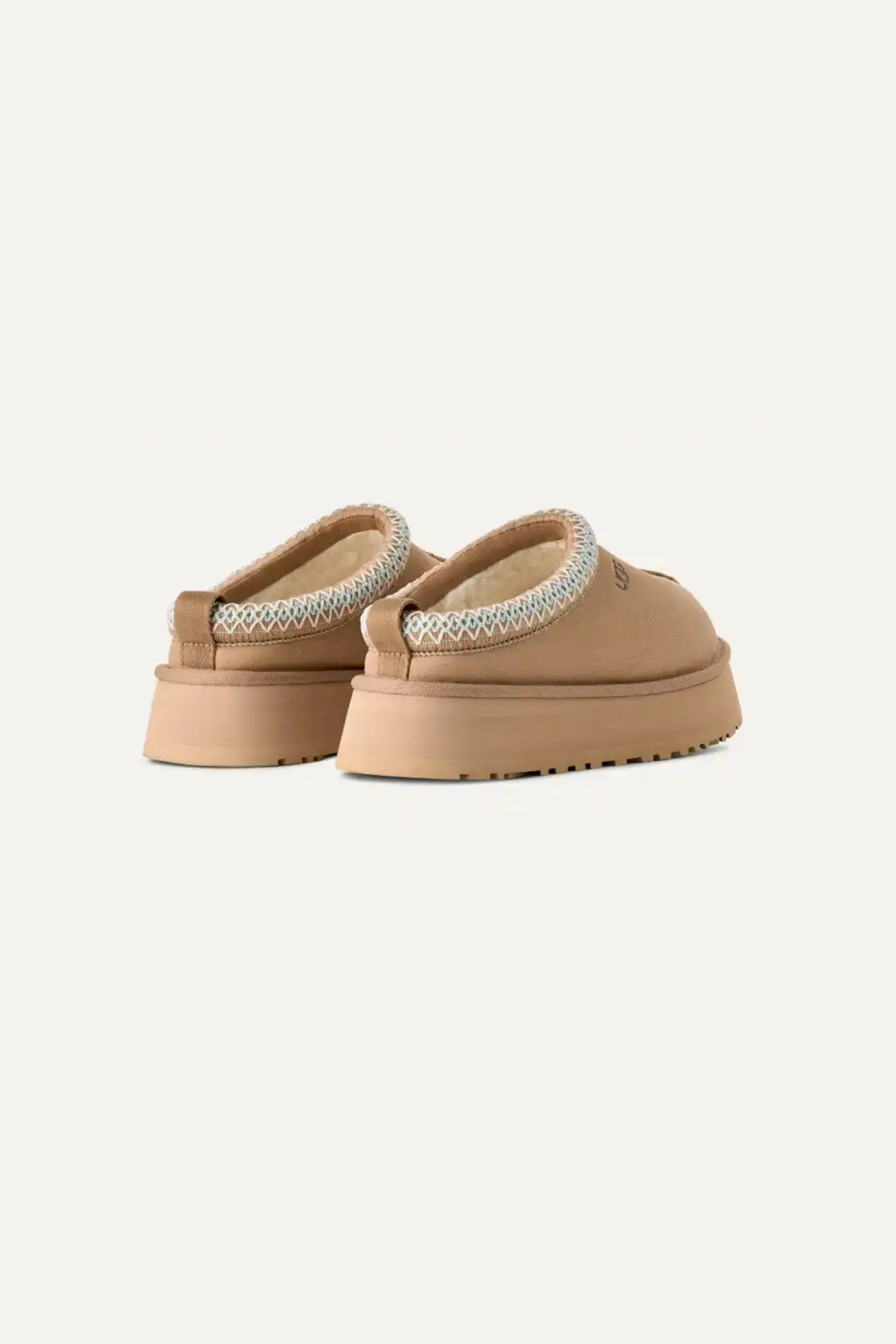 UGG women tazz in sand. Back view