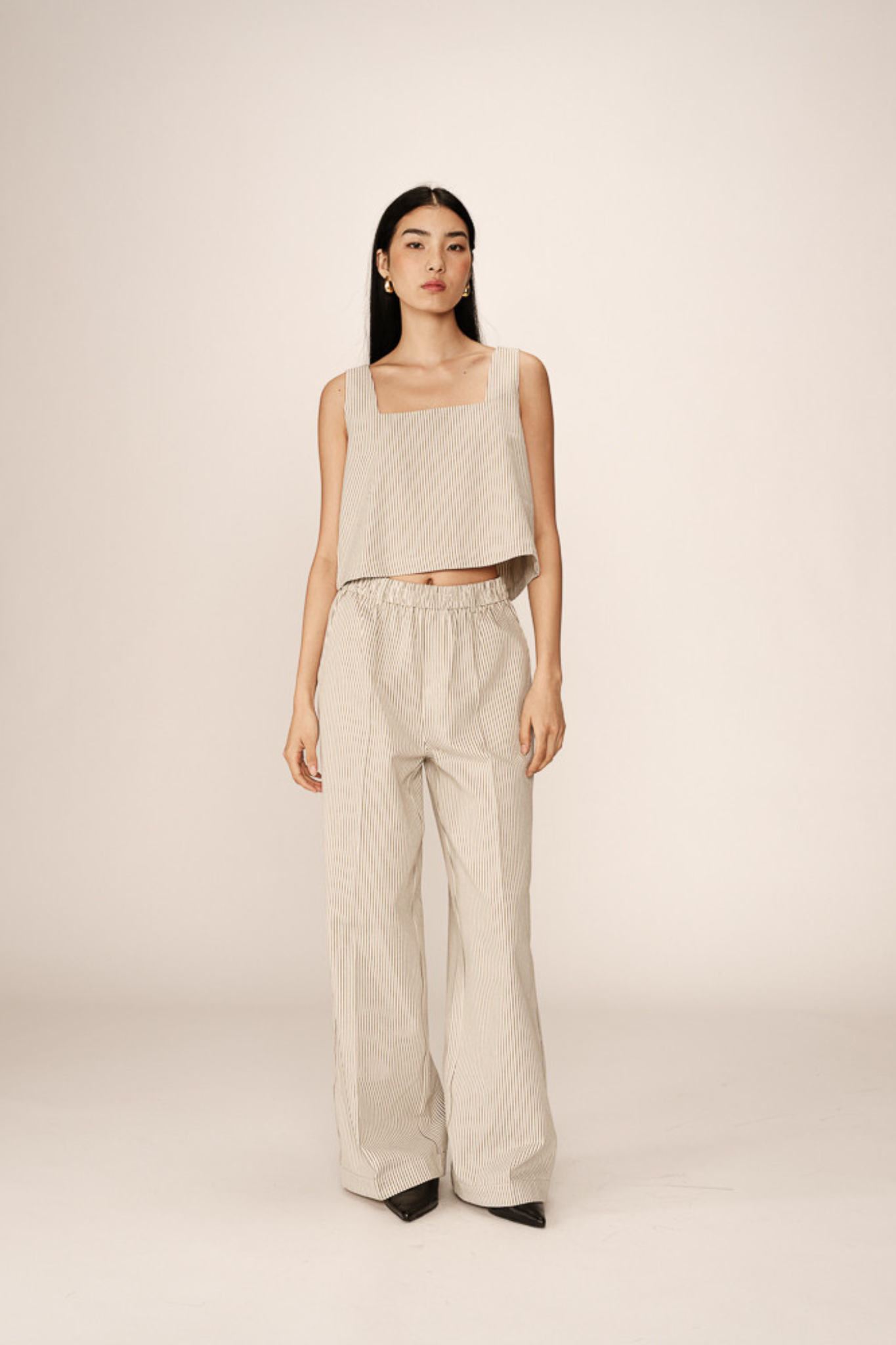 Model wearing the Grace & Mila peanut top in ecru. Front view