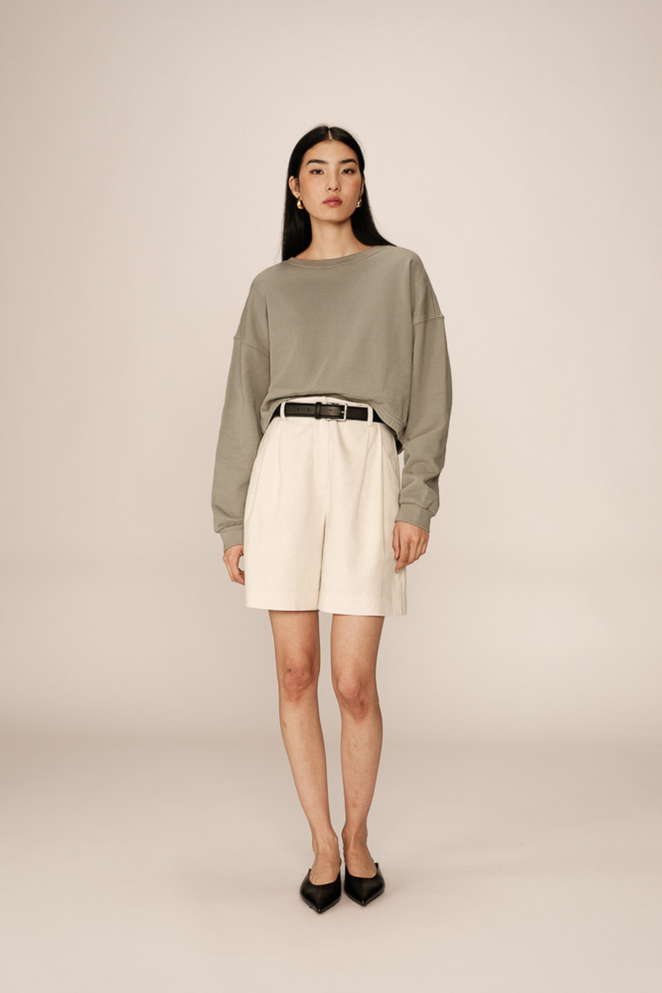 Model wearing the Grace & Mila podium sweatshirt in green. Front view