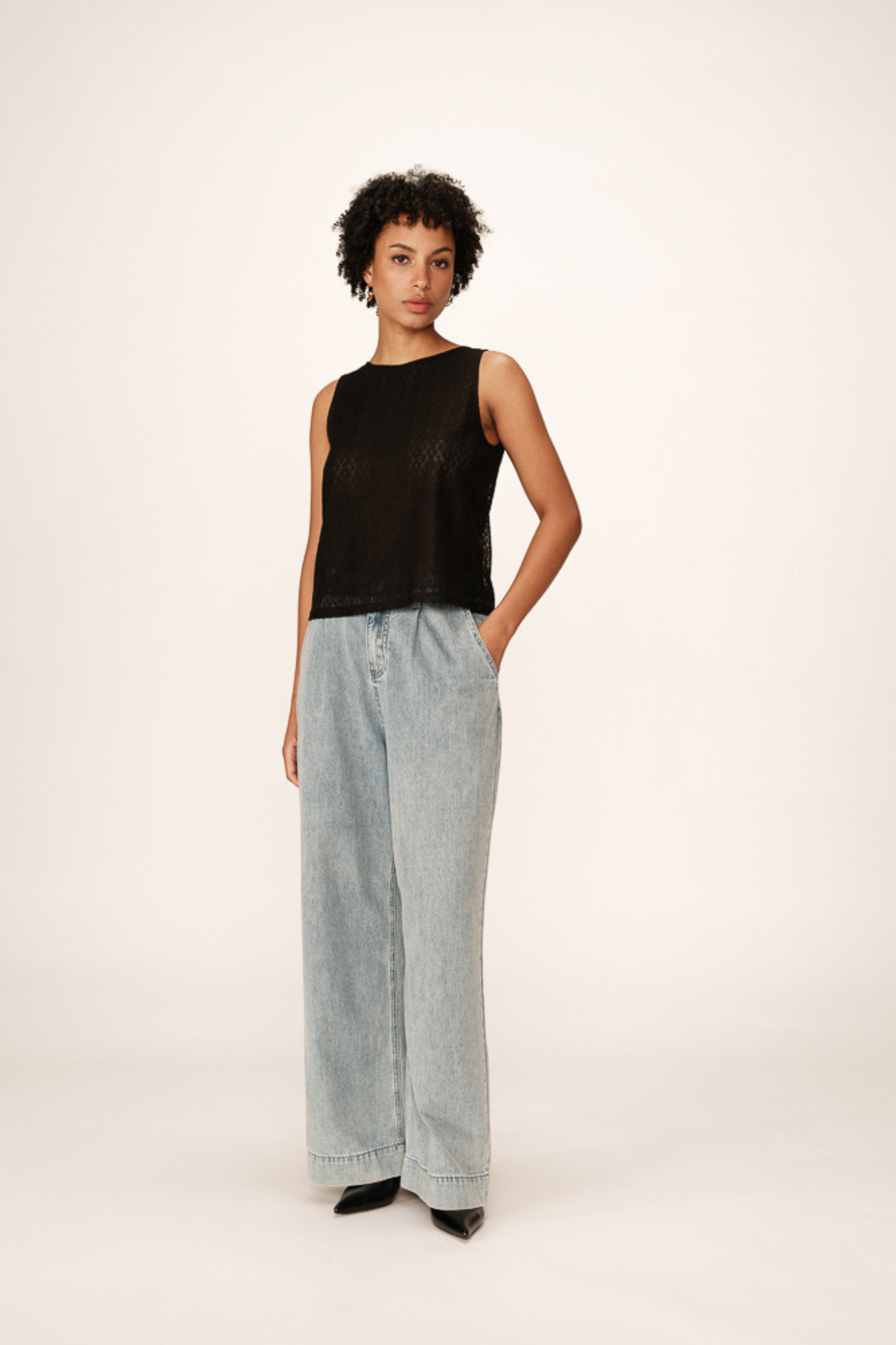 Model wearing the Grace & Mila passionnee top in black. Front view