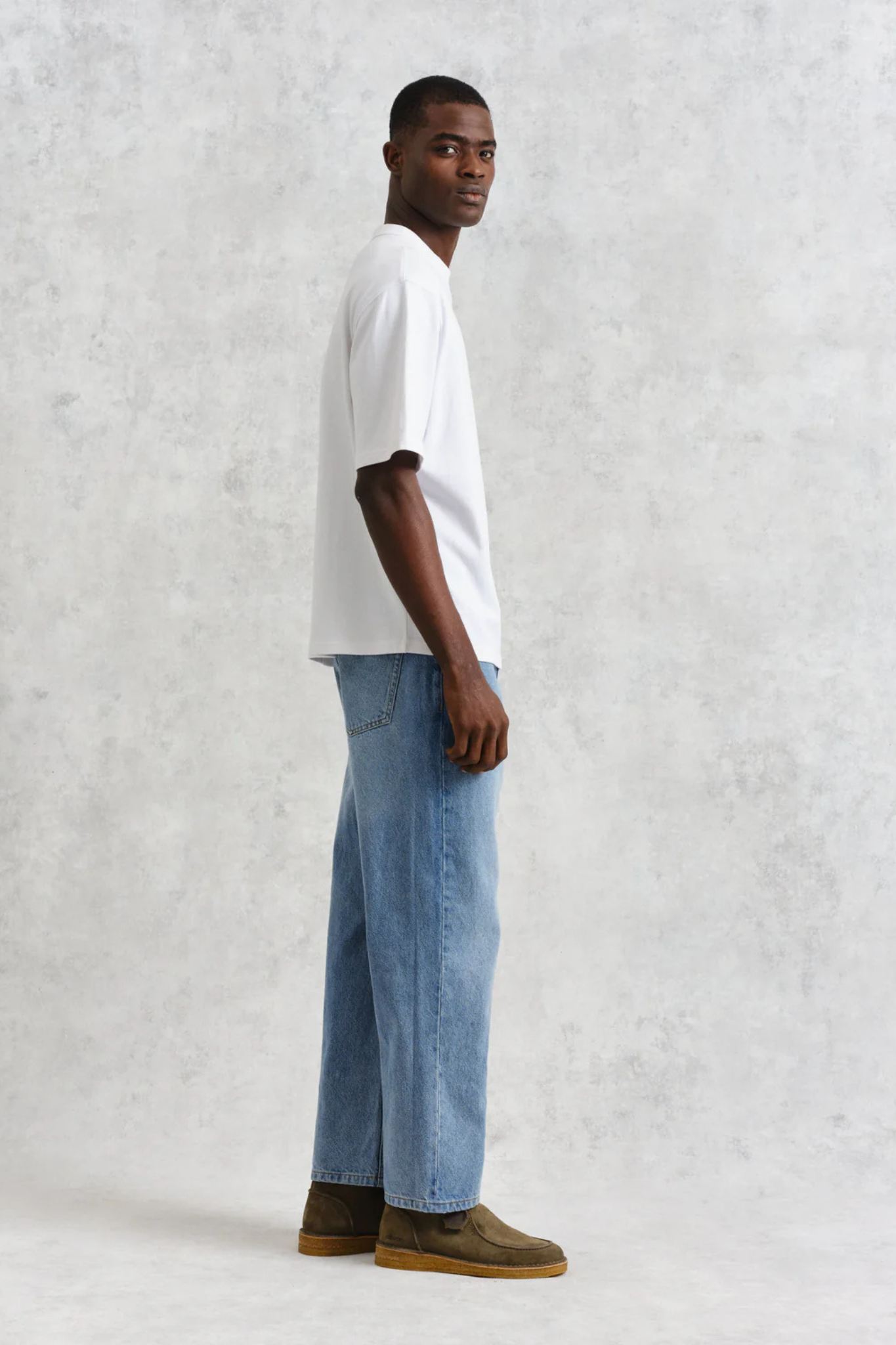 Model wearing the Wax London milton t-shirt in white. Side view