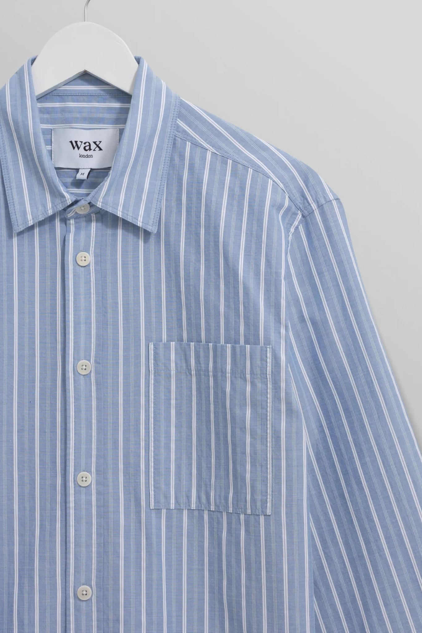 Wax London rove poplin stripe shirt in blue. Front flatlay view
