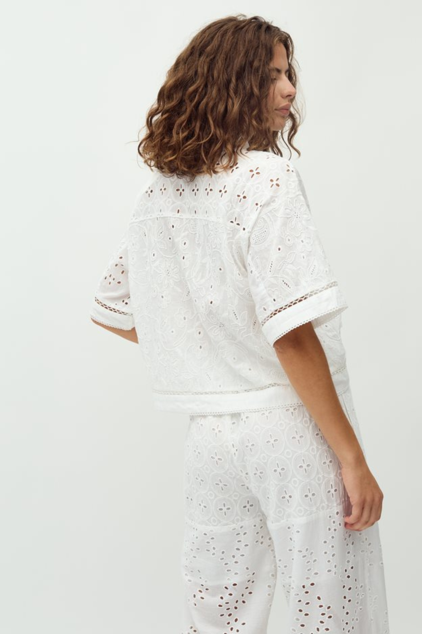 Model wearing the MBYM sonja embroidery shirt in white. Back view