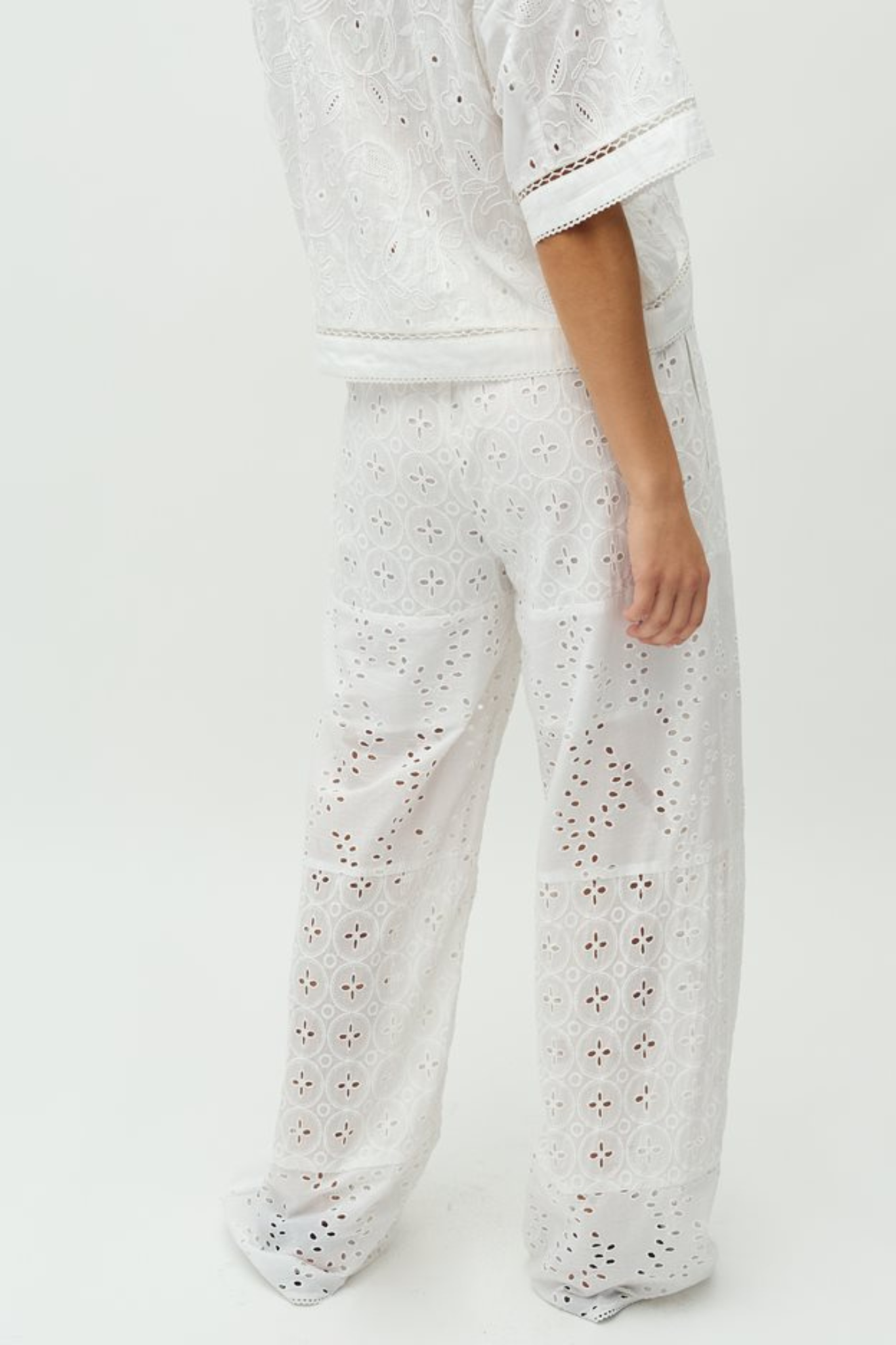 Model wearing the MBYM viljane embroidery pants in white. Back view