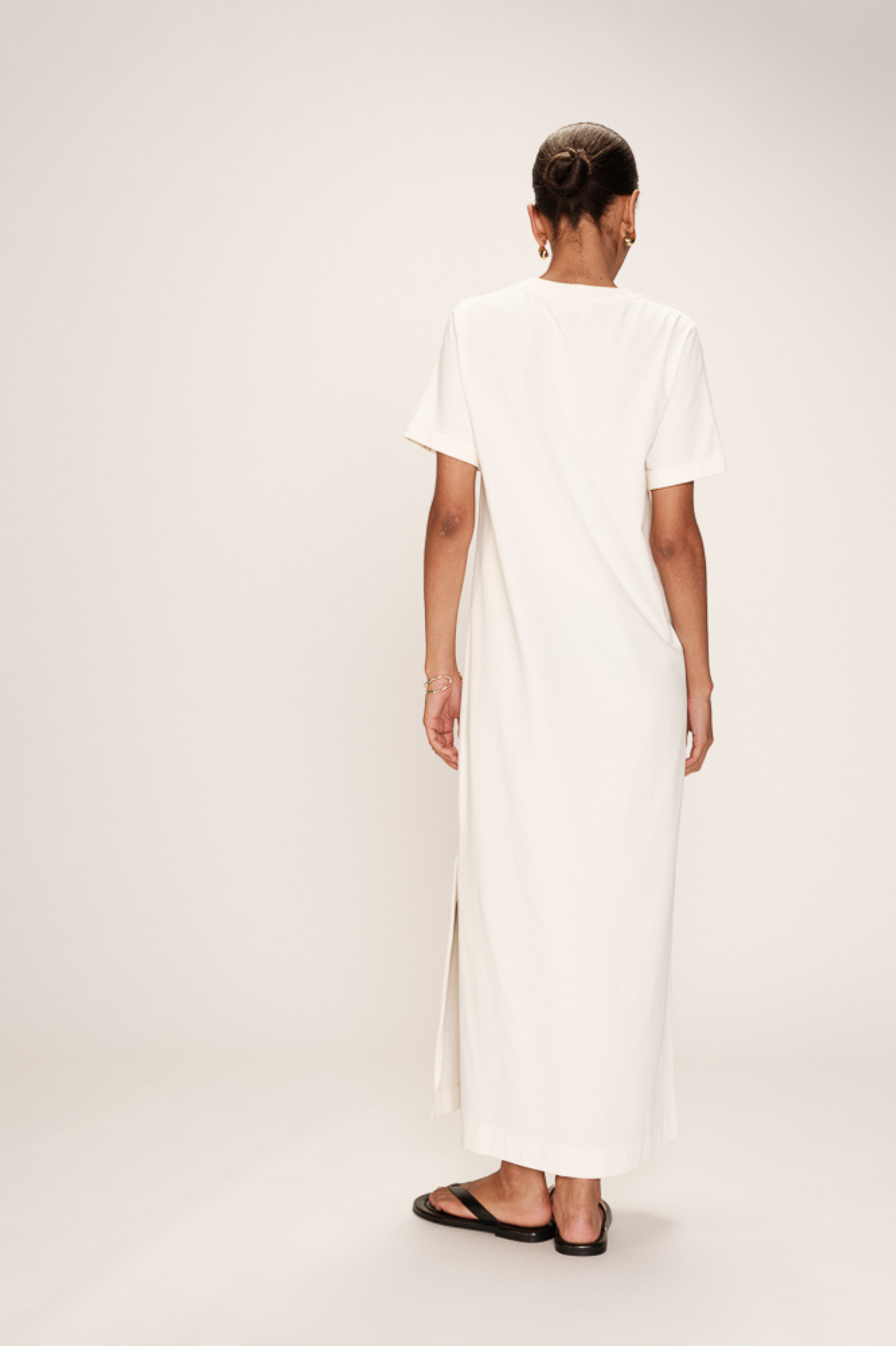 Model wearing the Grace & Mila rosalie dress in ecru. Back view