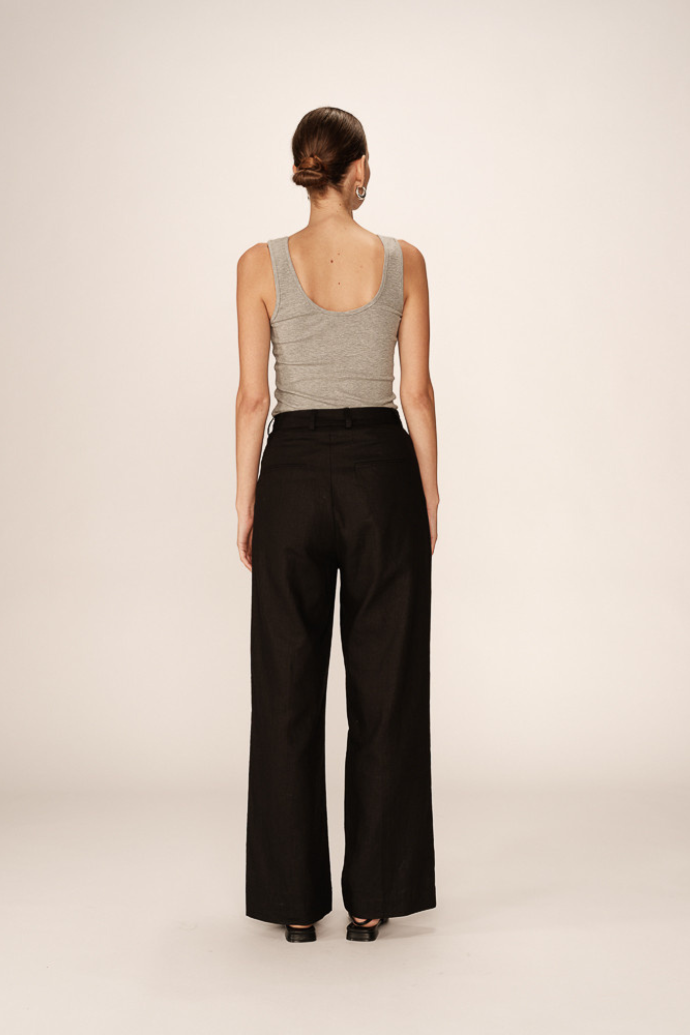 Model wearing the Grace & Mila phil pants in black. Back view