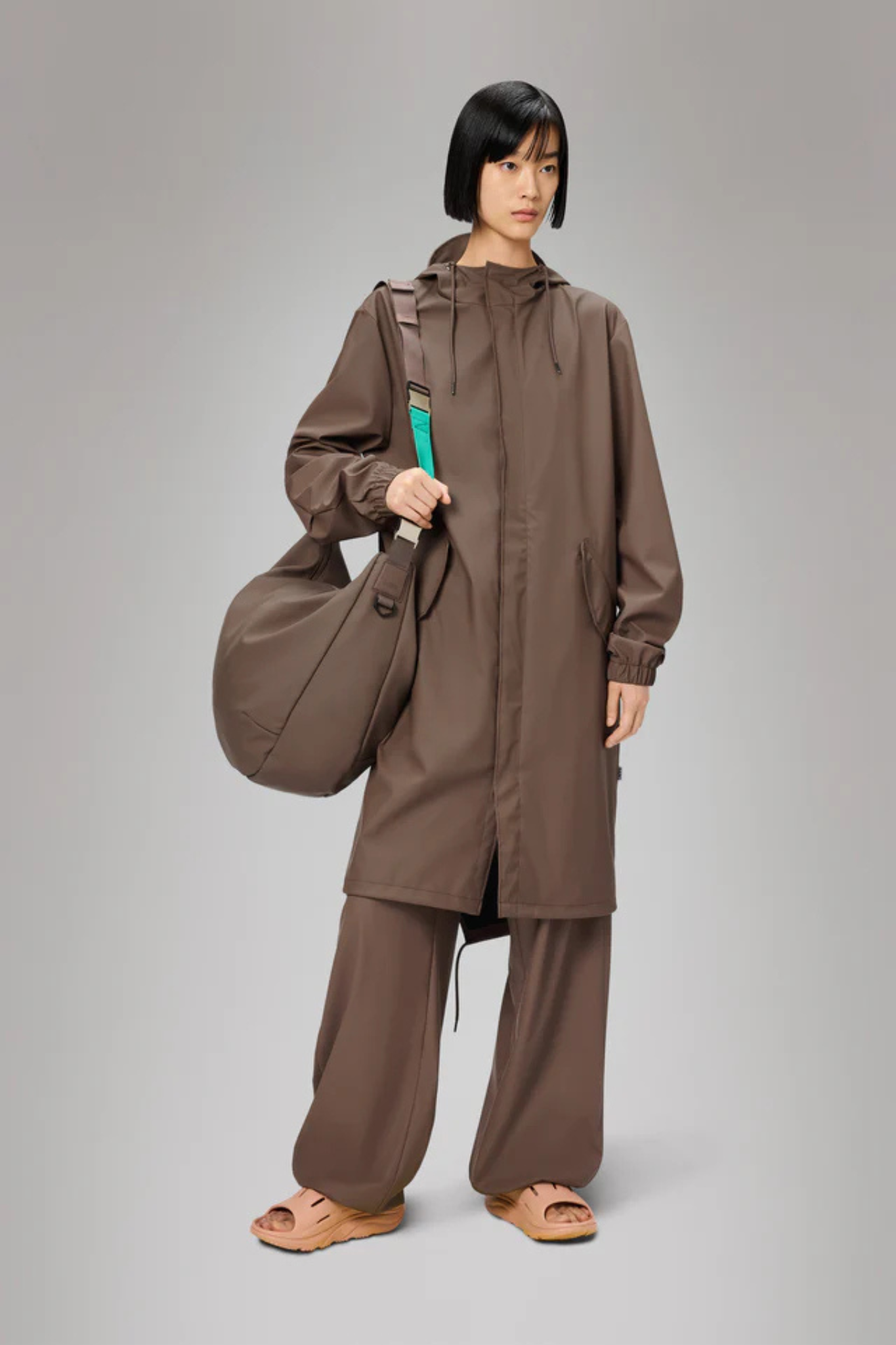 Model wearing the Rains fishtail parka W3 in shade. Front view