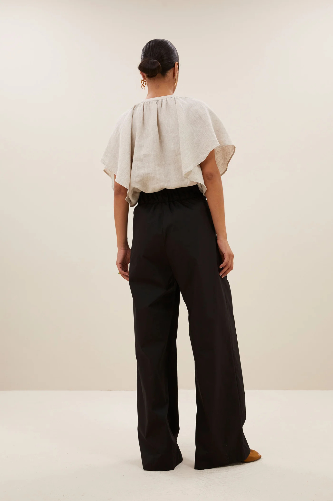 Model wearing the By-Bar benji poplin pants in black. Back view