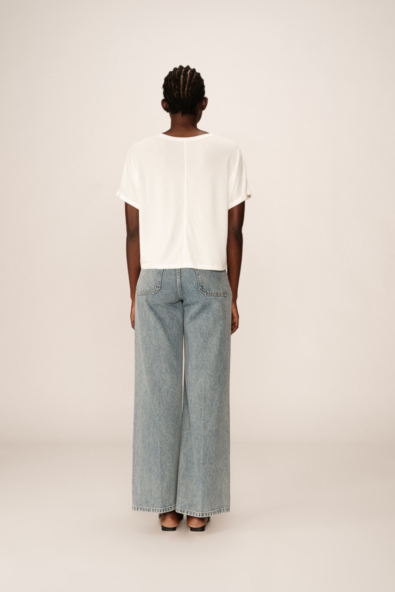 Model wearing the Grace & Mila parma t-shirt in ecru. Back view