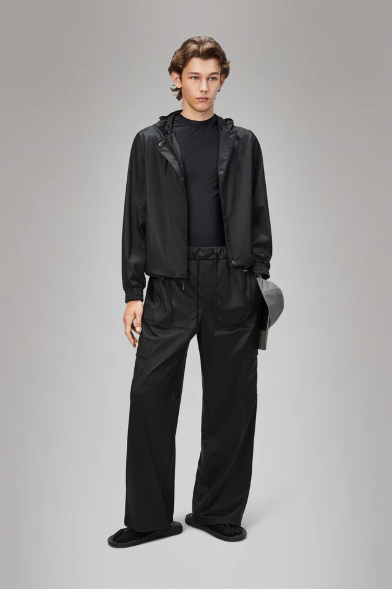 Model wearing the Rains string jacket W3 in black. Front view