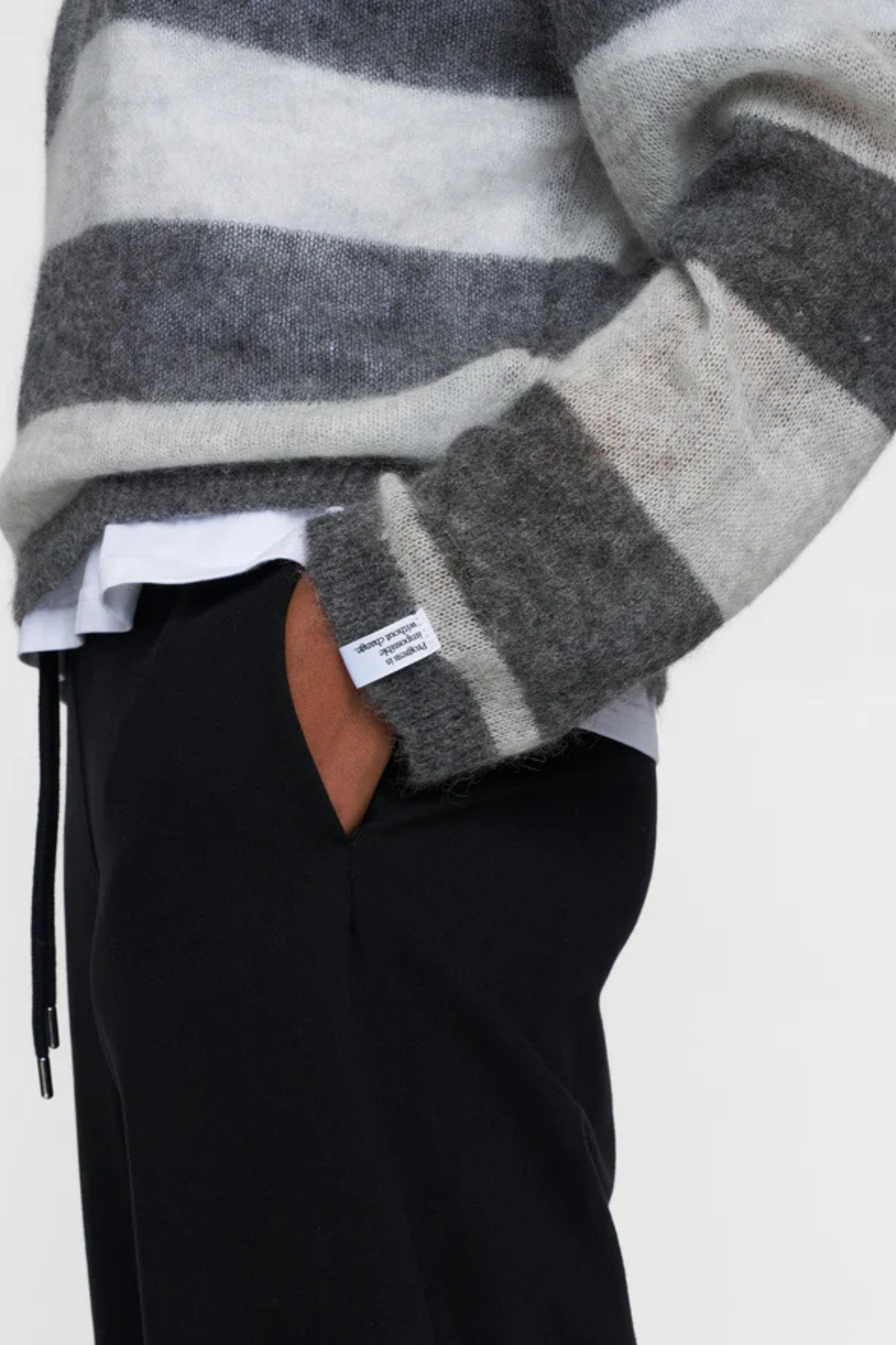 Model wearing the 10days thin knit sweater in antra melle/white grey melee. Close side view
