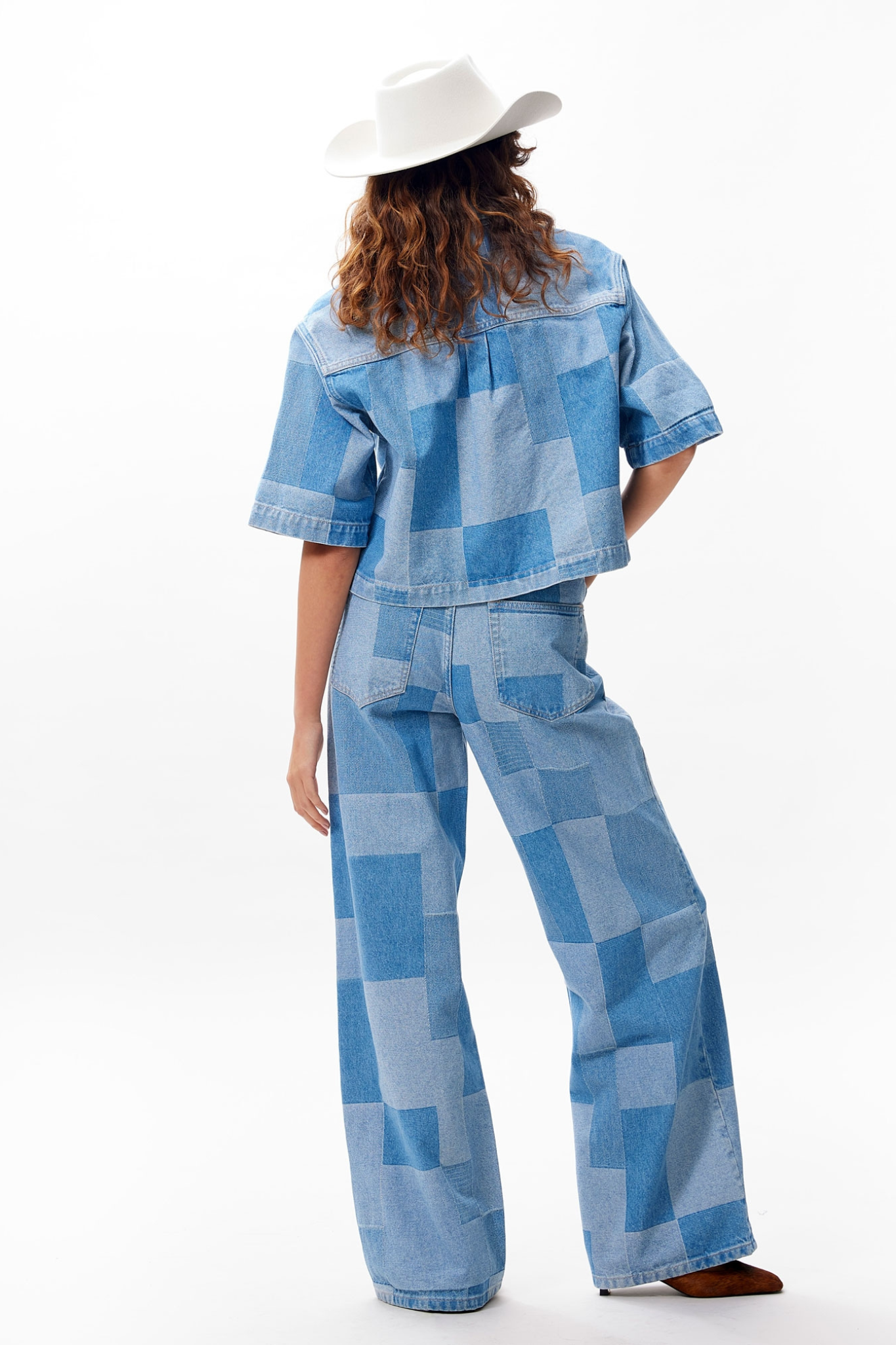Model wearing the Catwalk Junkie patchwork blouse in blue. Back view