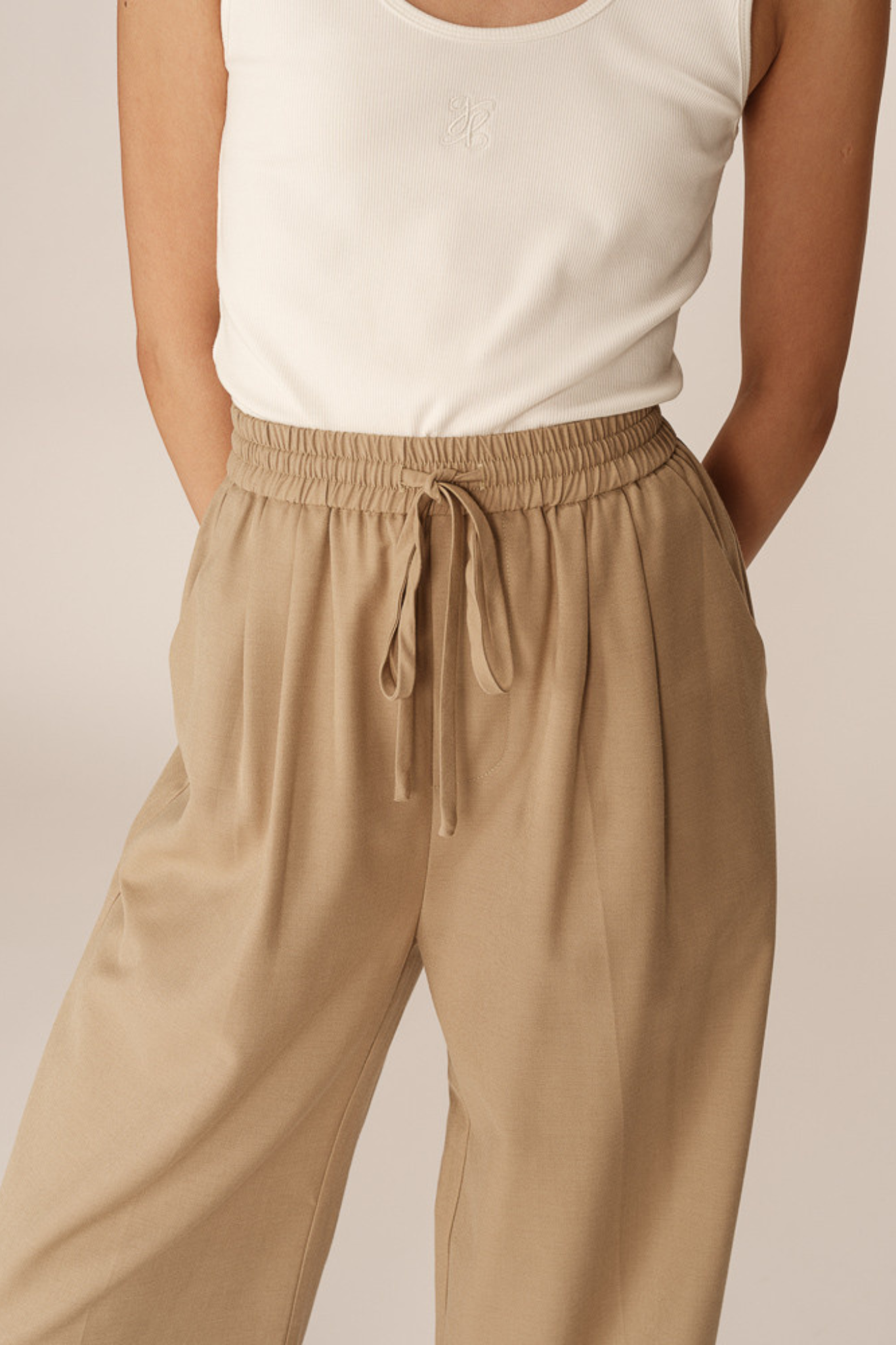 Model wearing the Grace & Mila petro pants in beige. Close front view
