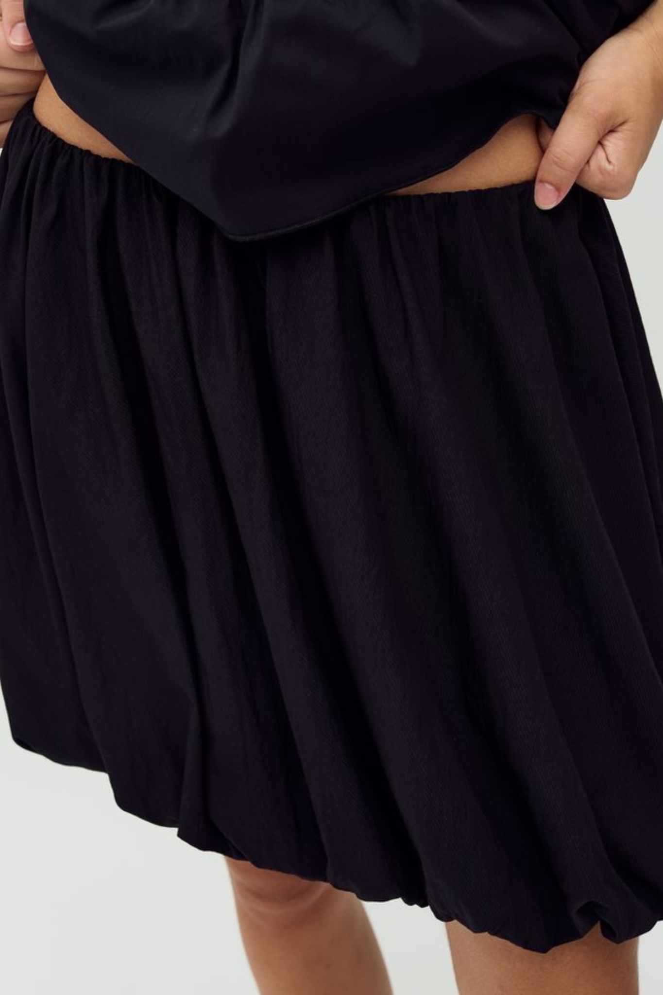 Model wearing the MBYM belaria twilia skirt in black. Close front view