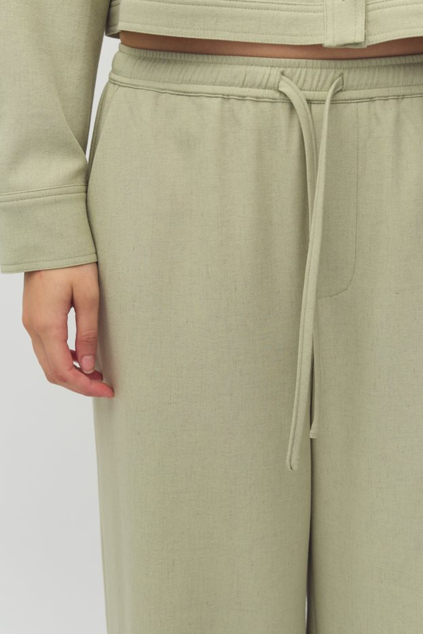 Model wearing the MBYM christoff morenna pants in pistachio/green. Close front view