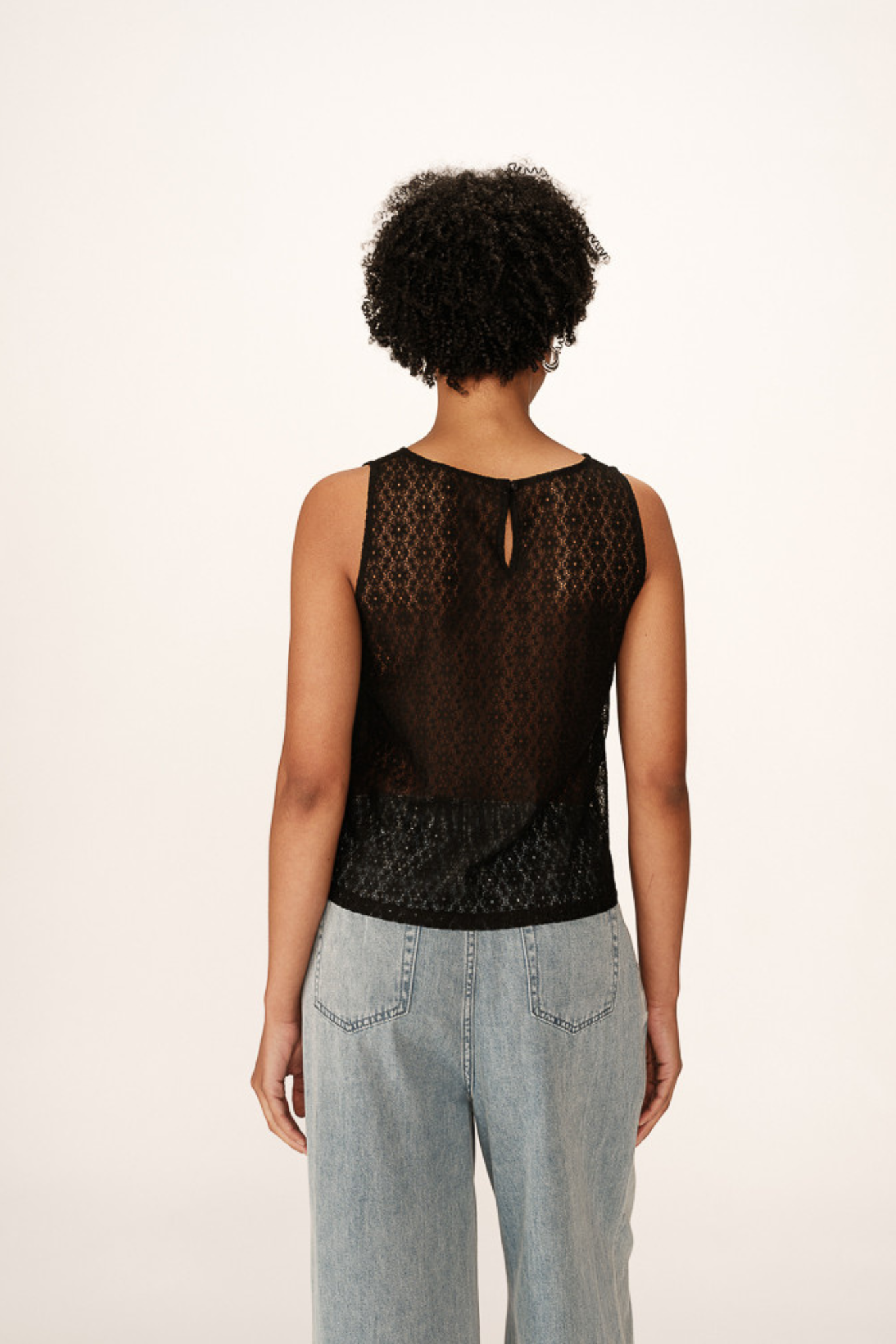 Model wearing the Grace & Mila passionnee top in black. Back view