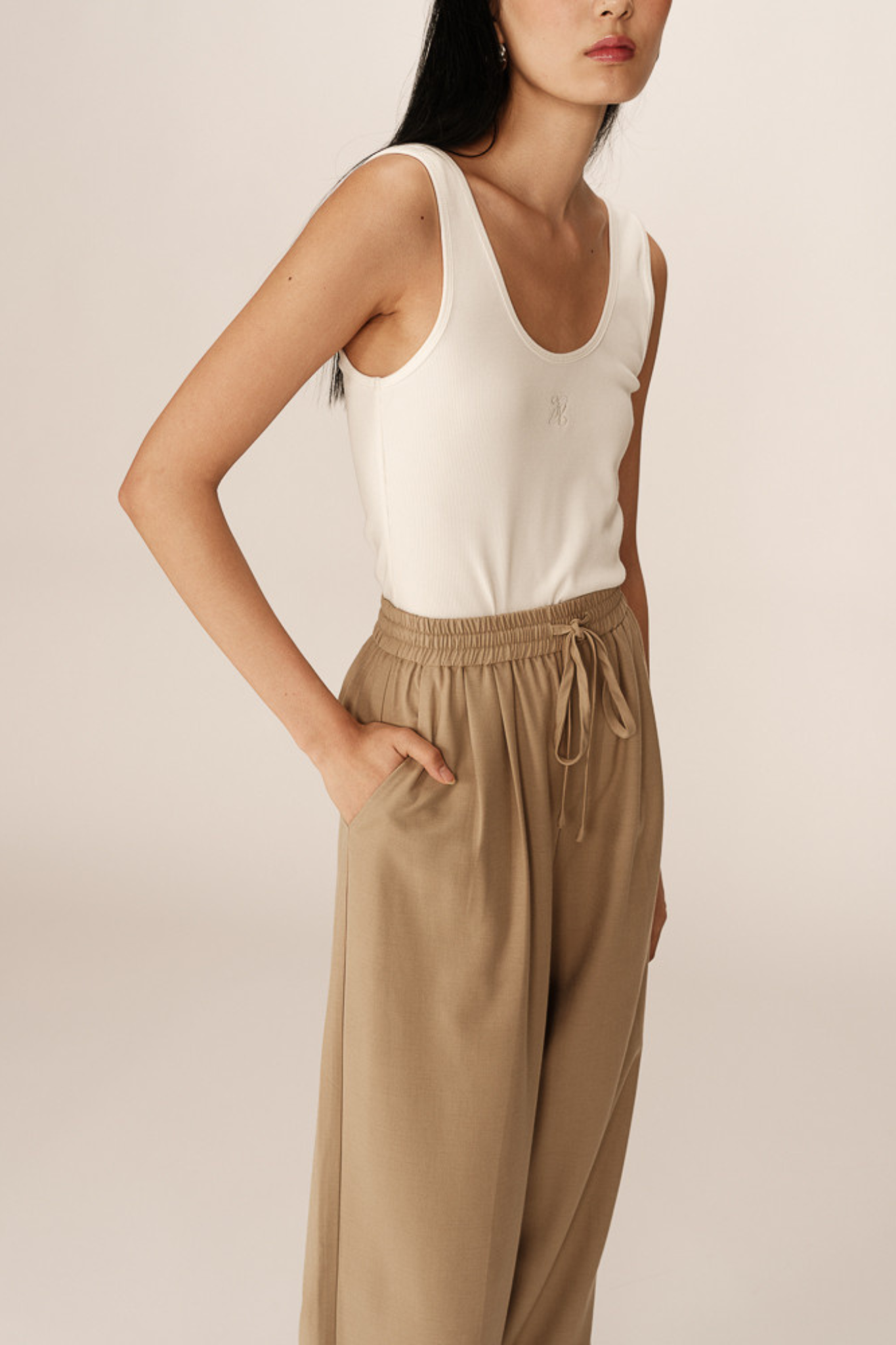 Model wearing the Grace & Mila petro pants in beige. Side view