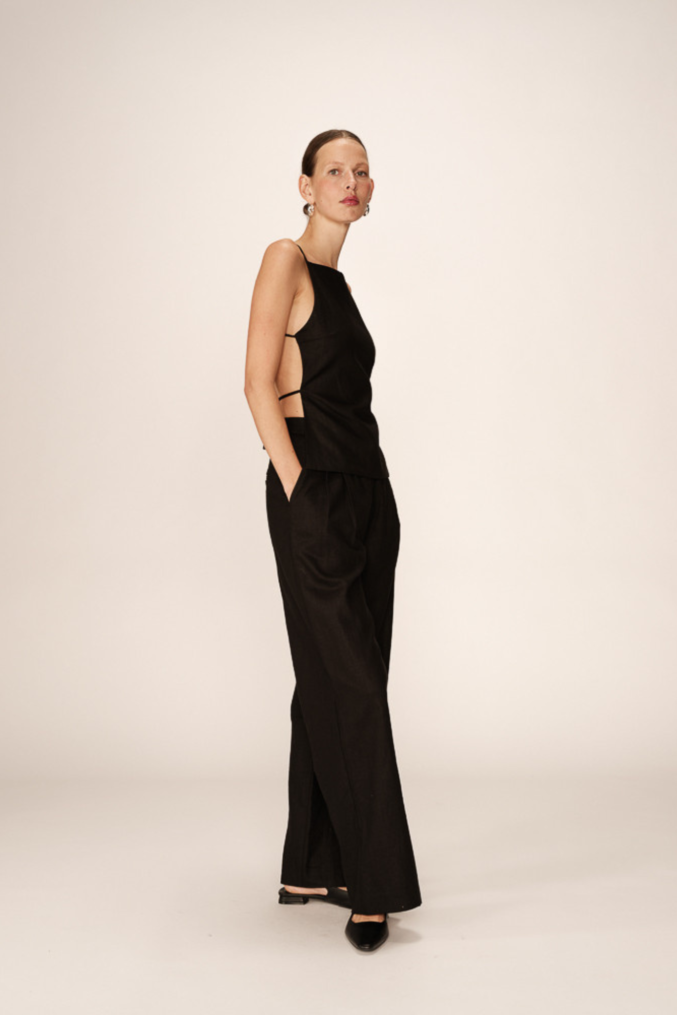 Model wearing the Grace & Mila phil pants in black. Side view