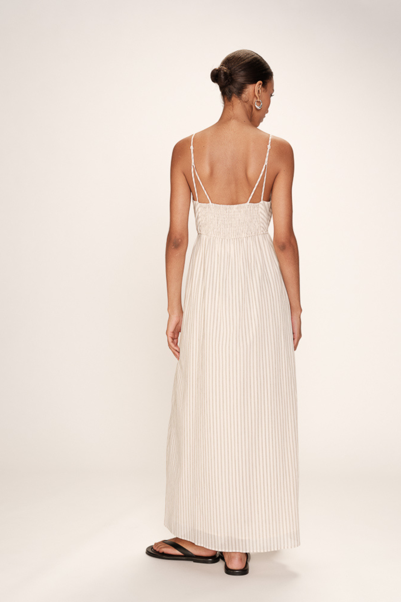Model wearing the Grace & Mila raja dress in ecru. Back view