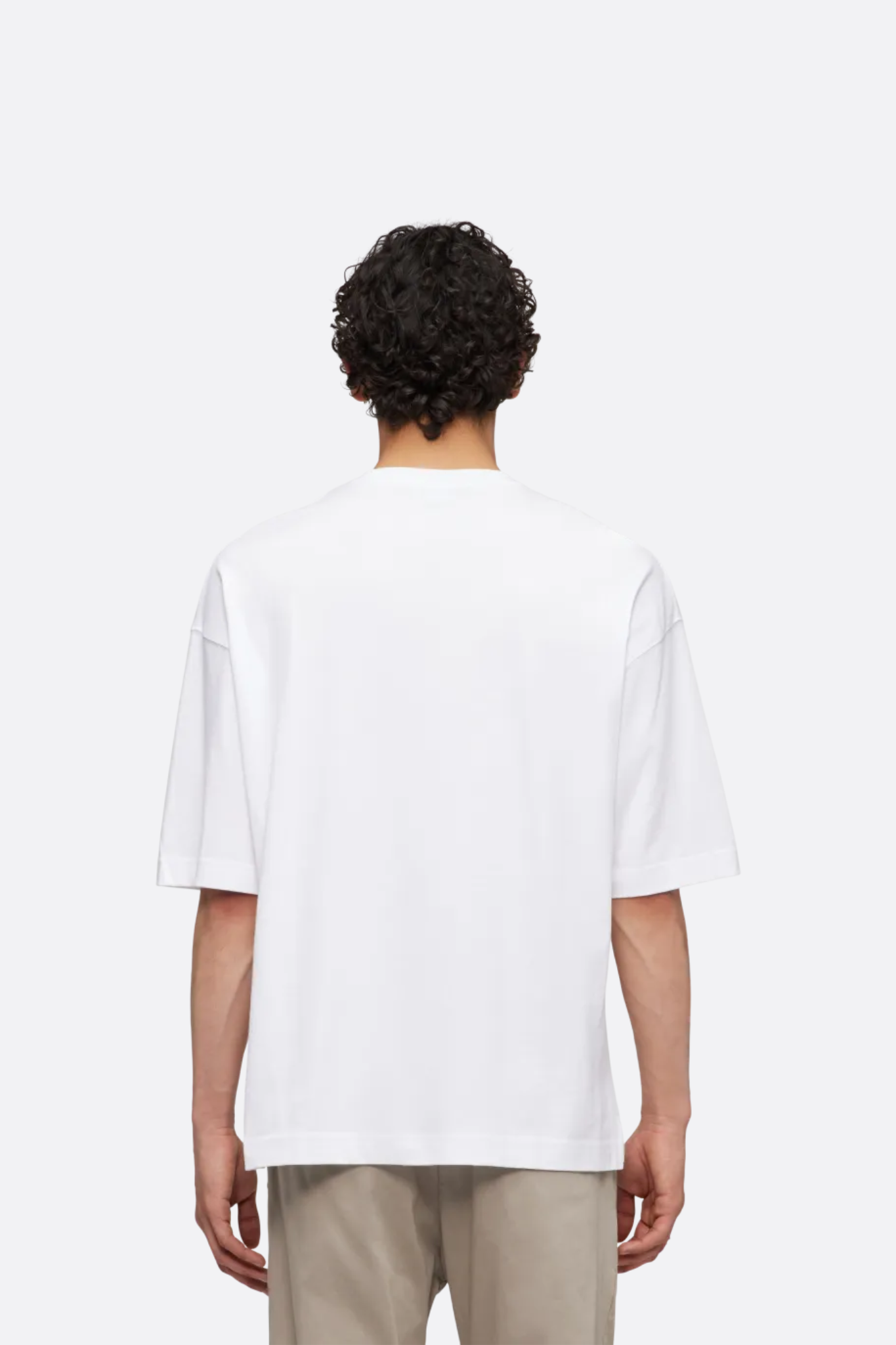 Model wearing the Drykorn mategon t-shirt in white. Back view