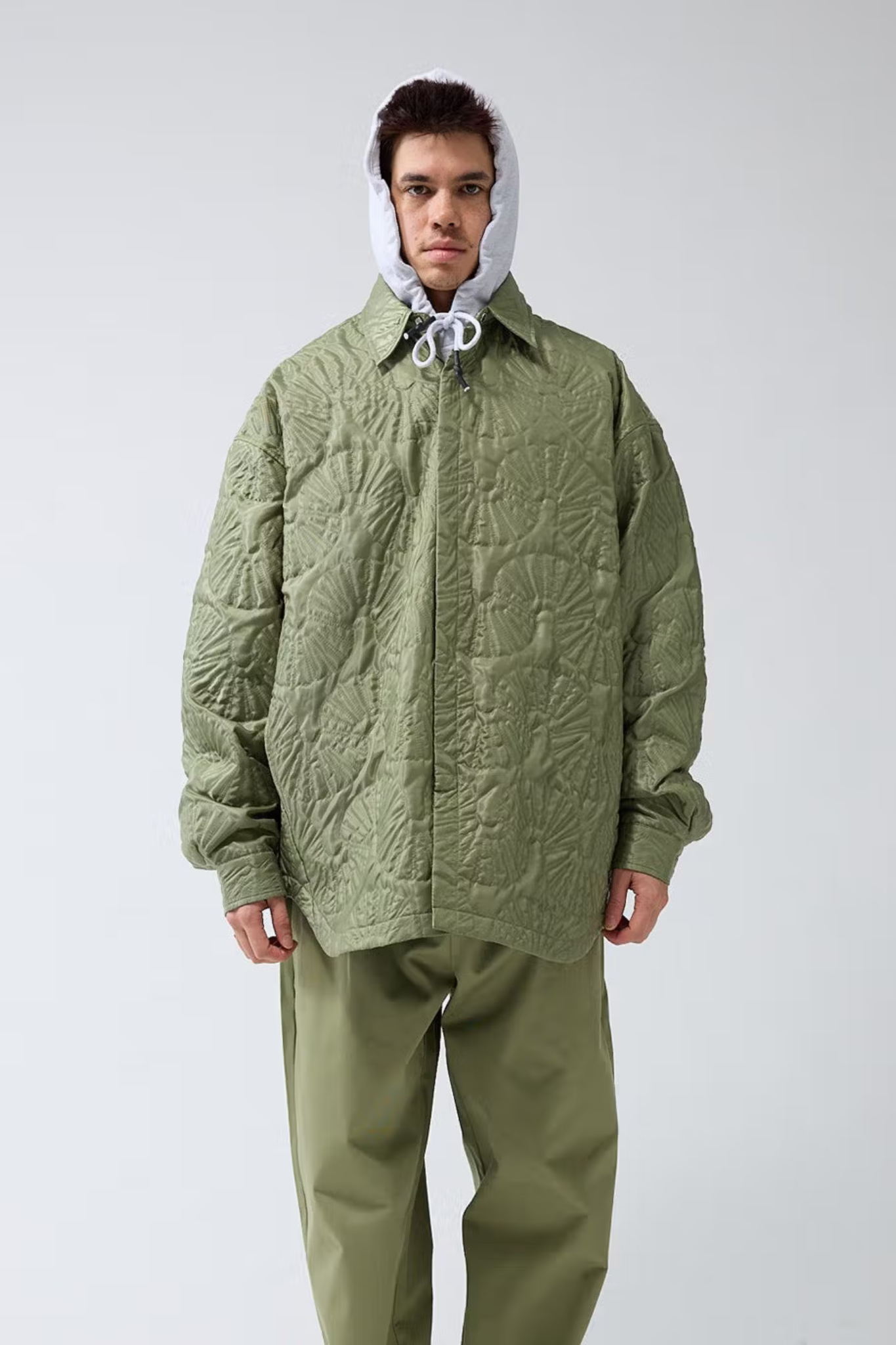 Model wearing the New Amsterdam shell quilted overshirt in green. Front view