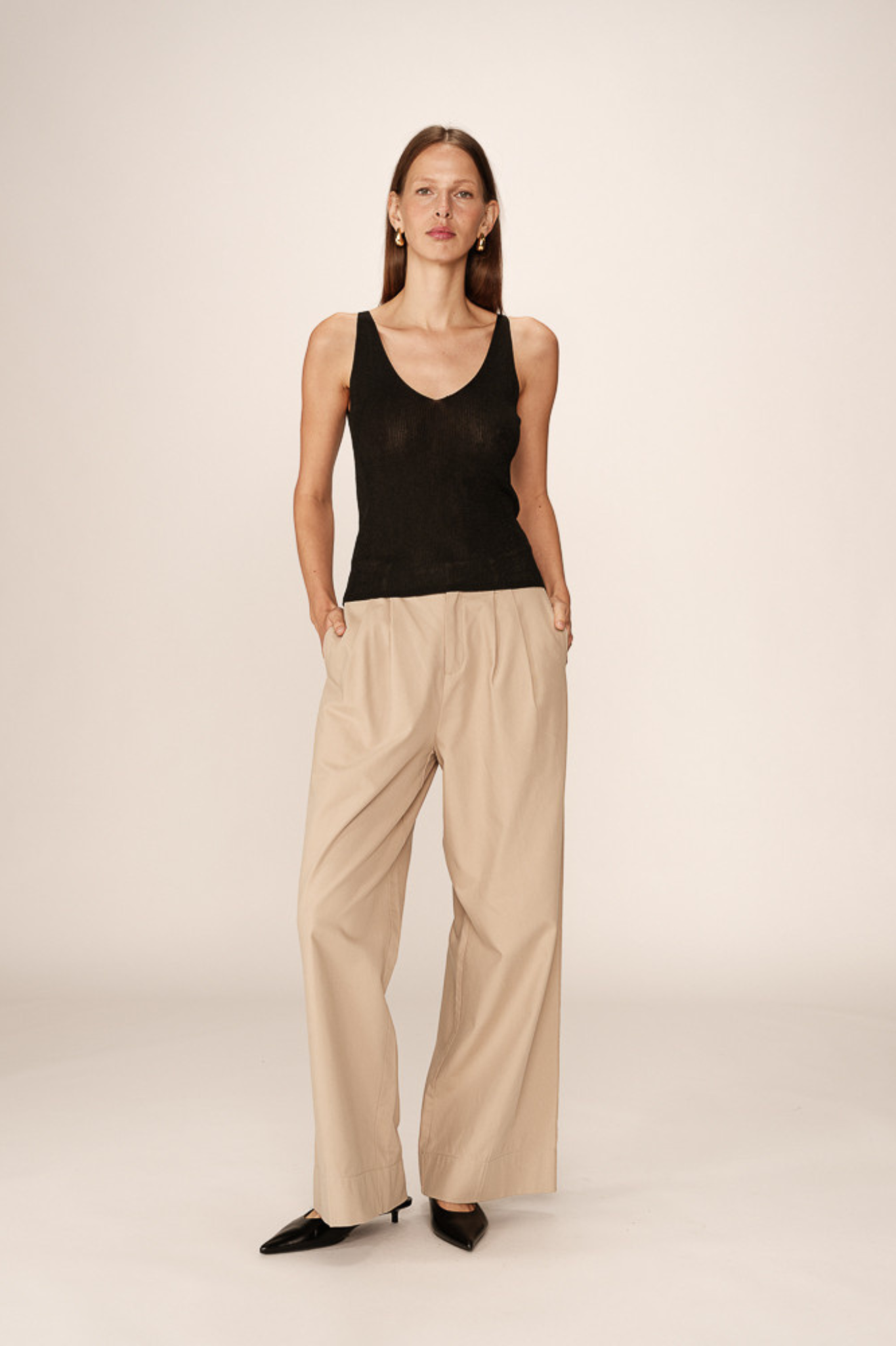 Model wearing the Grace & Mila paillette top in black. Front view
