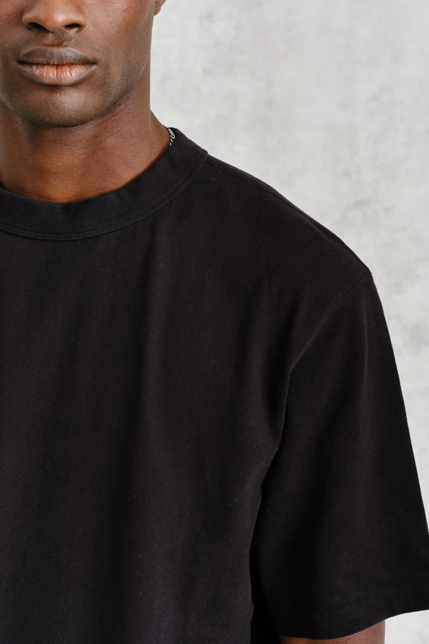Model wearing the Wax London milton t-shirt in black. Close front view