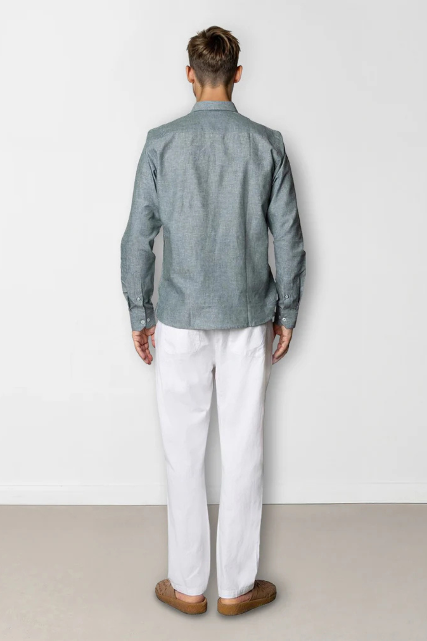 Model wearing the Clean Cut Copenhagen jamie shirt in dark green melange. Back view