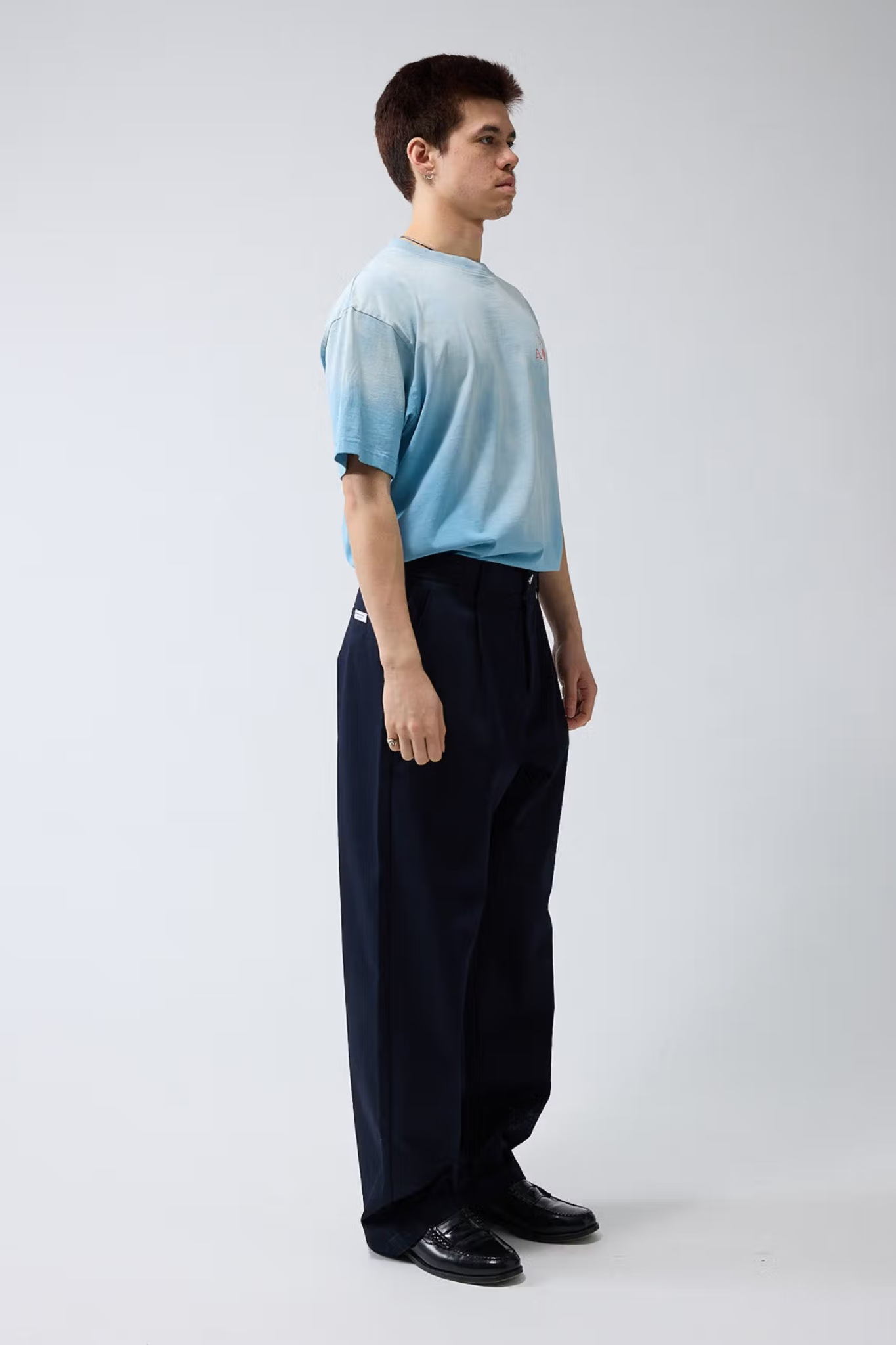 Model wearing the New Amsterdam reworked pants in night blue. Side view