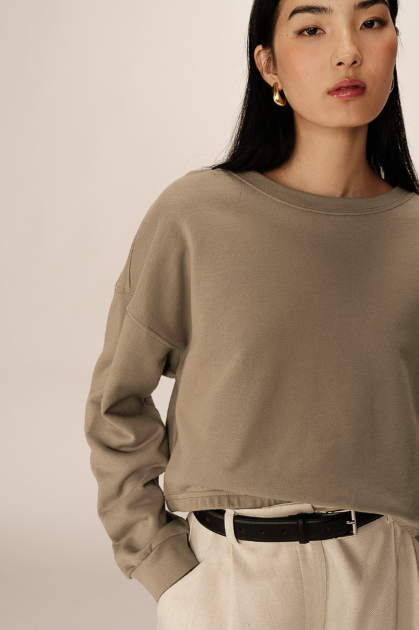 Model wearing the Grace & Mila podium sweatshirt in green. Front view