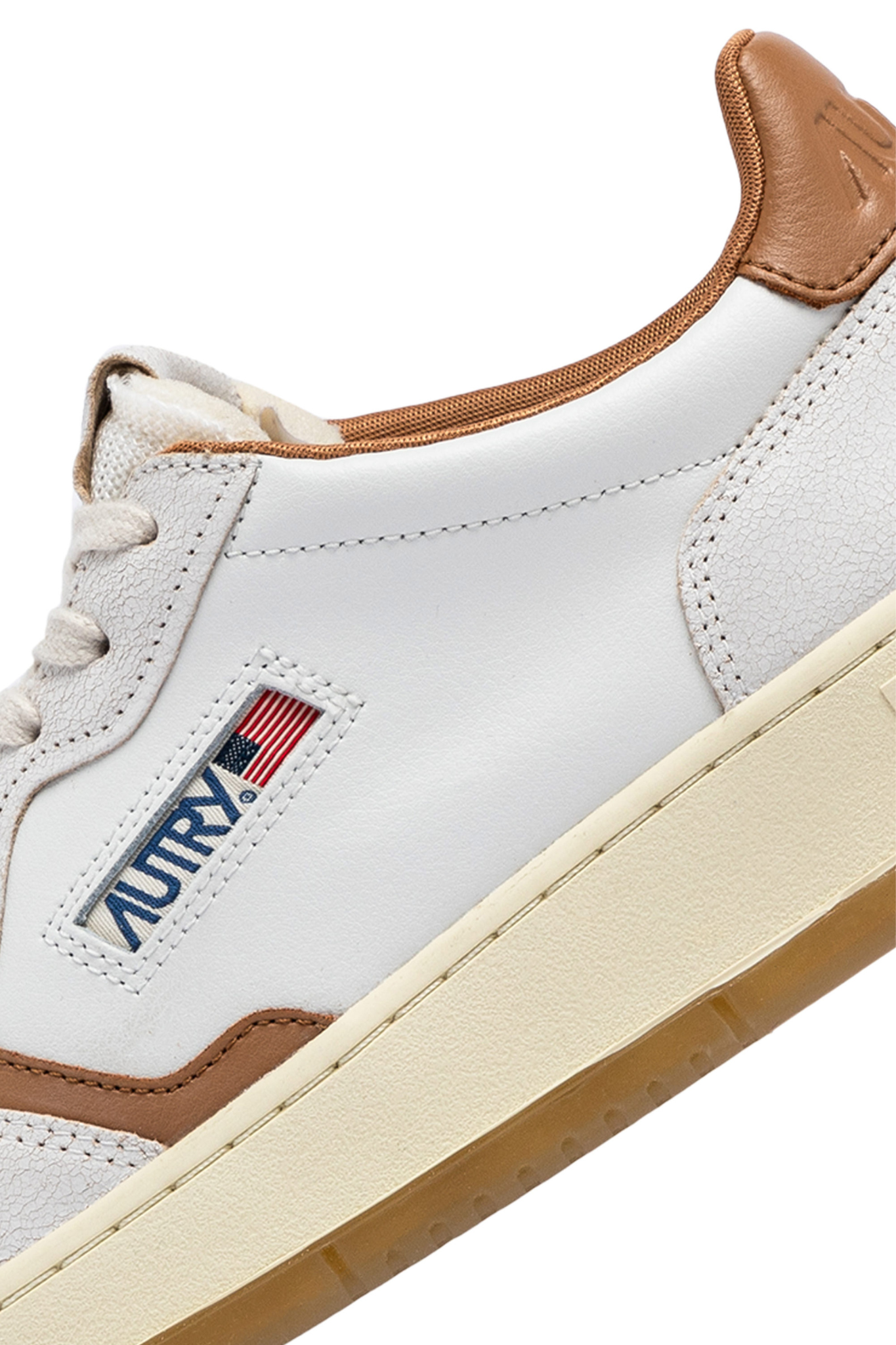 Autry medalist low man sneakers in white and brown. Close side view