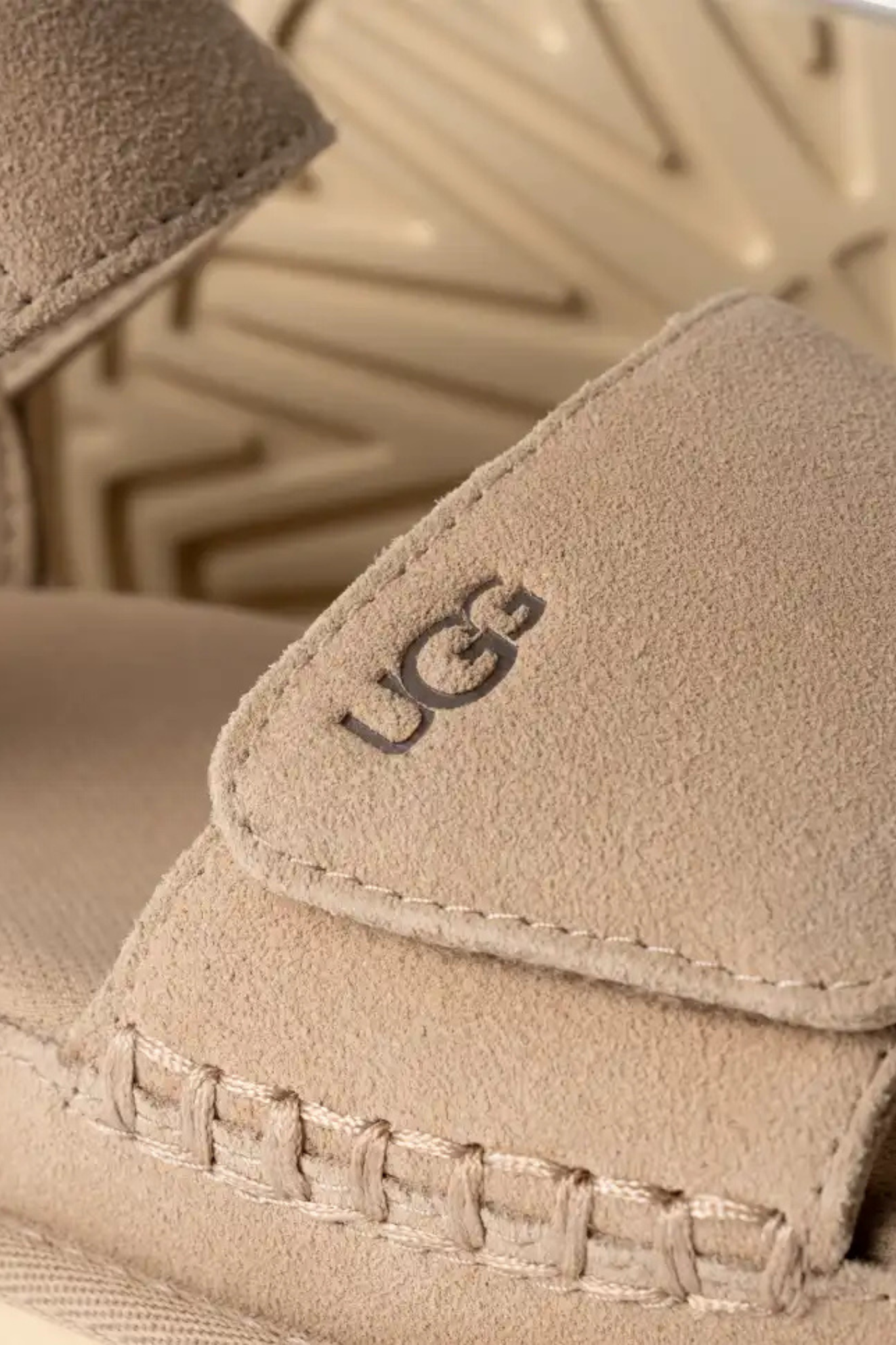 UGG women goldenstar in sand. Close logo view